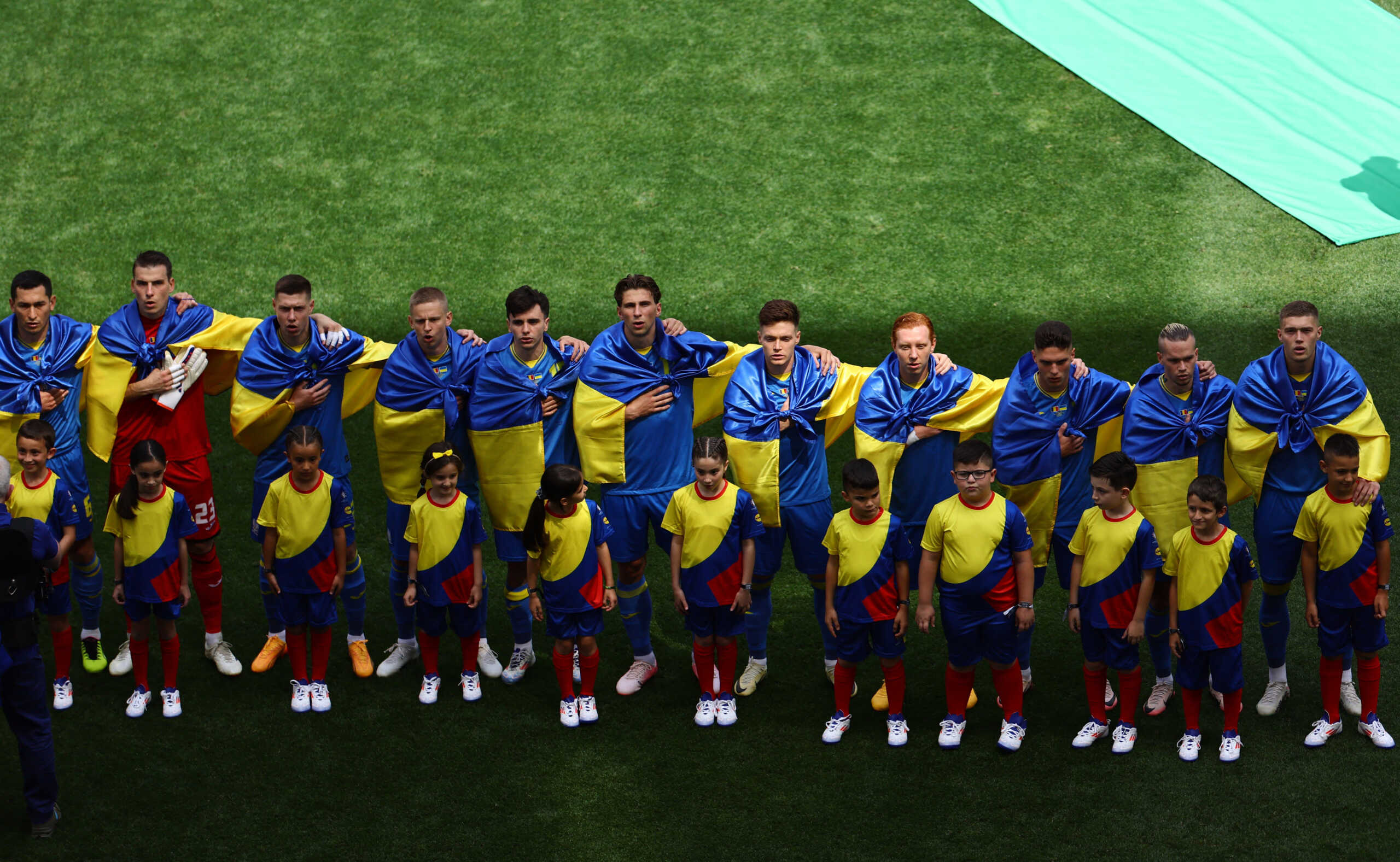 Soccer Football - Euro 2024 - Group E - Romania v Ukraine - Munich Football Arena, Munich, Germany - June 17, 2024 Ukraine players line up during the national anthems before the match REUTERS