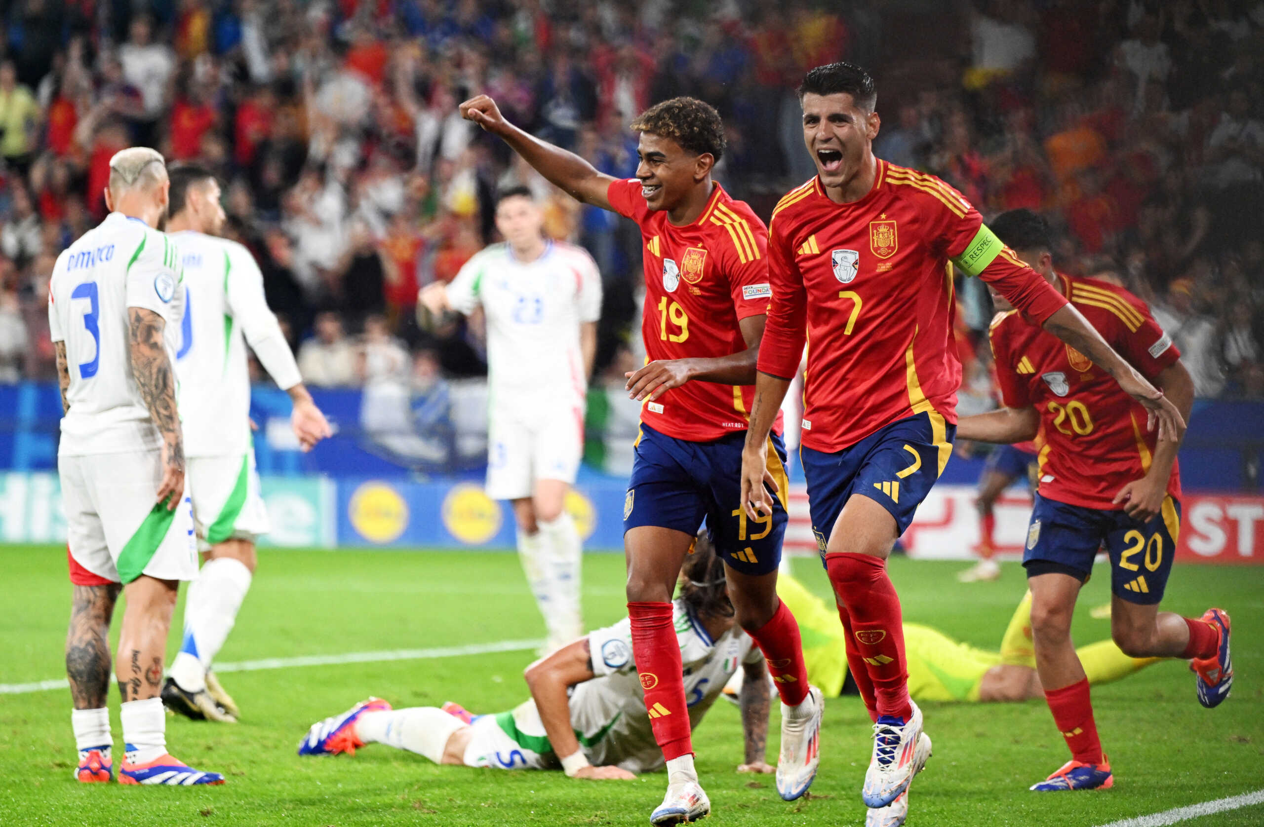 Soccer Football - Euro 2024 - Group B - Spain v Italy - Arena AufSchalke, Gelsenkirchen, Germany - June 20, 2024 Spain's Alvaro Morata and Lamine Yamal celebrate their first goal, an own goal scored by Italy's Riccardo Calafiori REUTERS