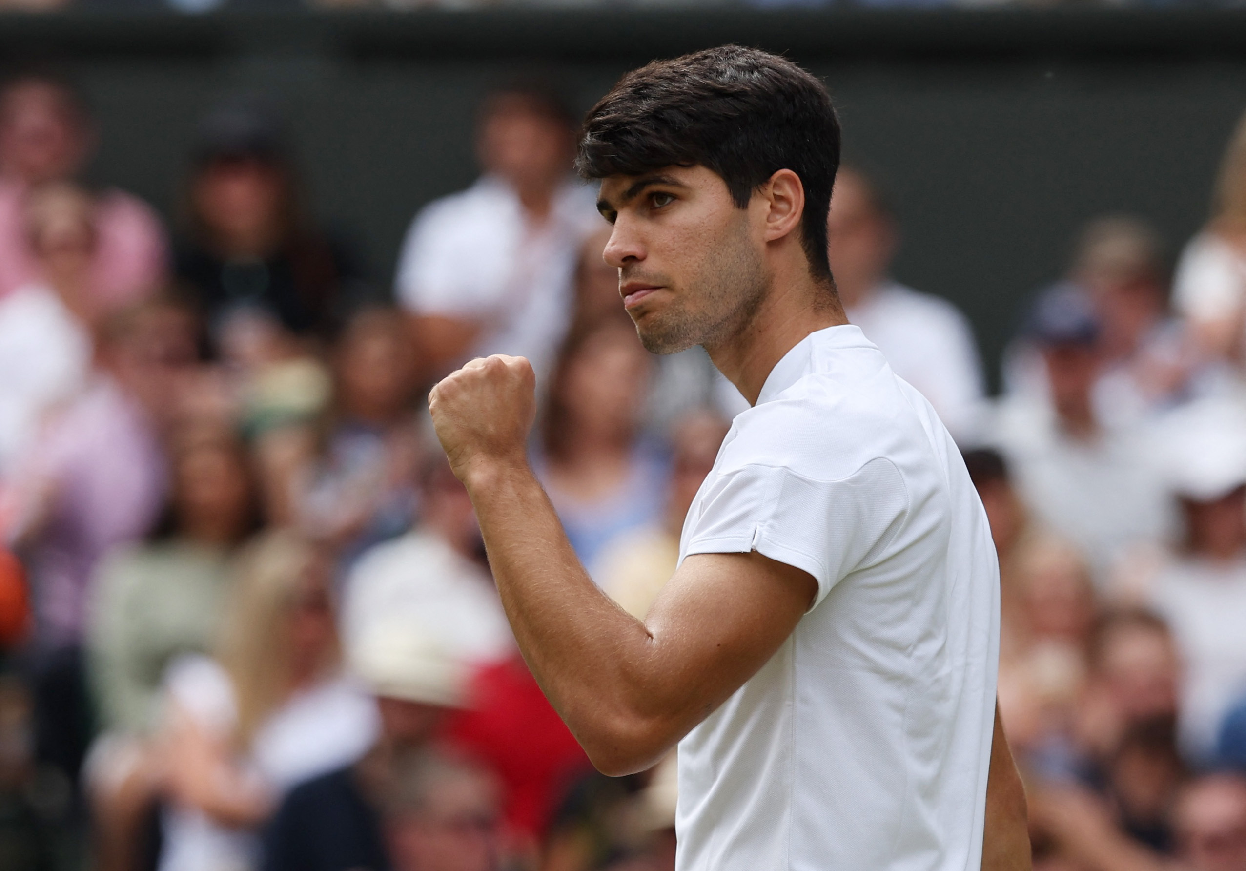 Tennis - Wimbledon - All England Lawn Tennis and Croquet Club, London, Britain - July 14, 2024 Spain's Carlos Alcaraz celebrates winning the second set during his men's singles final against Serbia's Novak Djokovic REUTERS