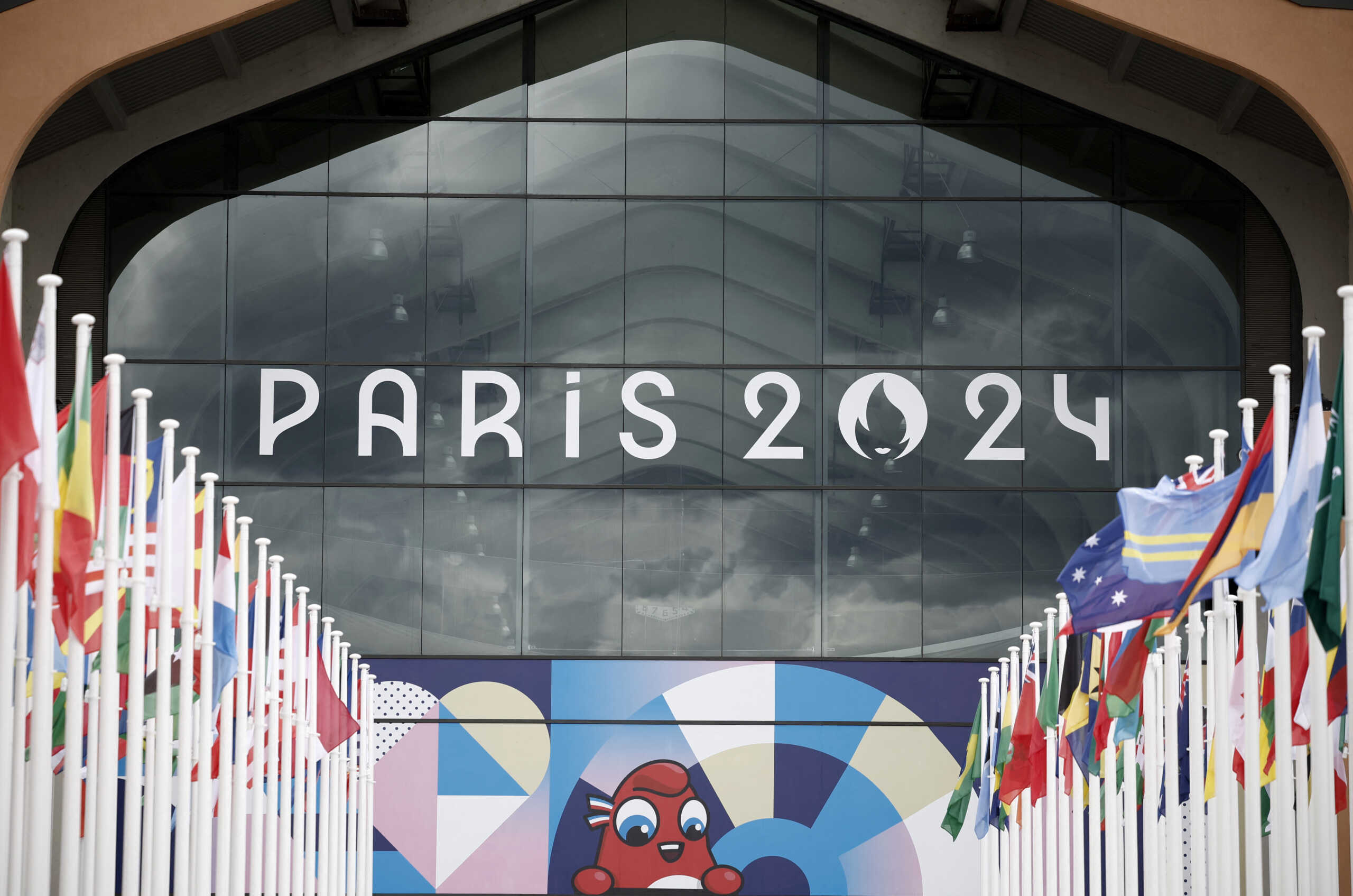 Paris 2024 Olympics - Press visit at the Olympic and Paralympic athletes Village - Saint-Denis, France - July 16, 2024 The Paris 2024 Olympics logo is seen along with mascot Olympic Phryge on a building in the Olympic village REUTERS