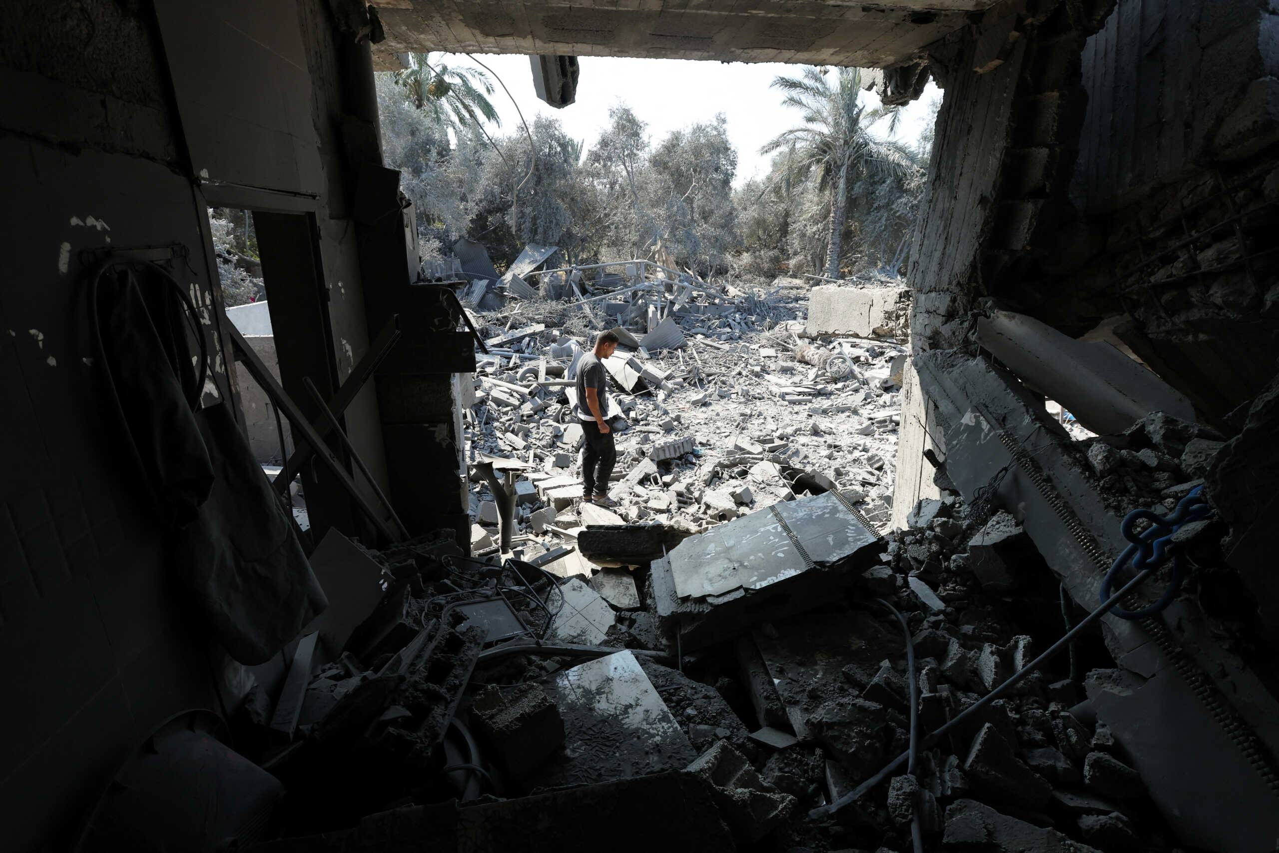 A Palestinian inspects a house destroyed in an Israeli strike, amid the Israel-Hamas conflict, in Nusairat refuge camp, in the central Gaza Strip, July 9, 2024. REUTERS