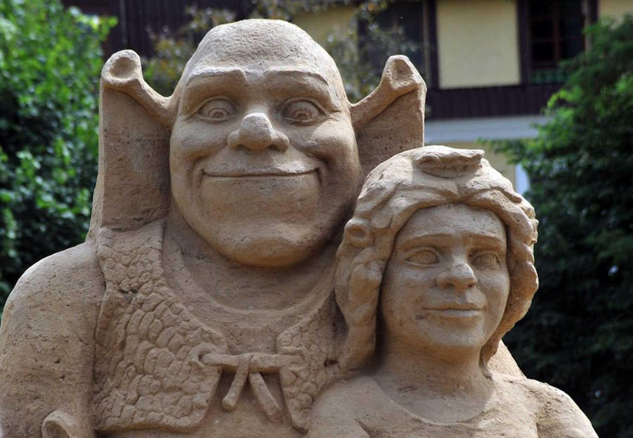 epa04313589 A sand sculpture of Shrek and Princess Fiona is on display at the second sand sculpture festival in Insko, Poland, 13 July 2014. Seven Polish sculptors created sand sculptures of fairy tale and cartoon characters for the festival that runs until 31 August.  EPA