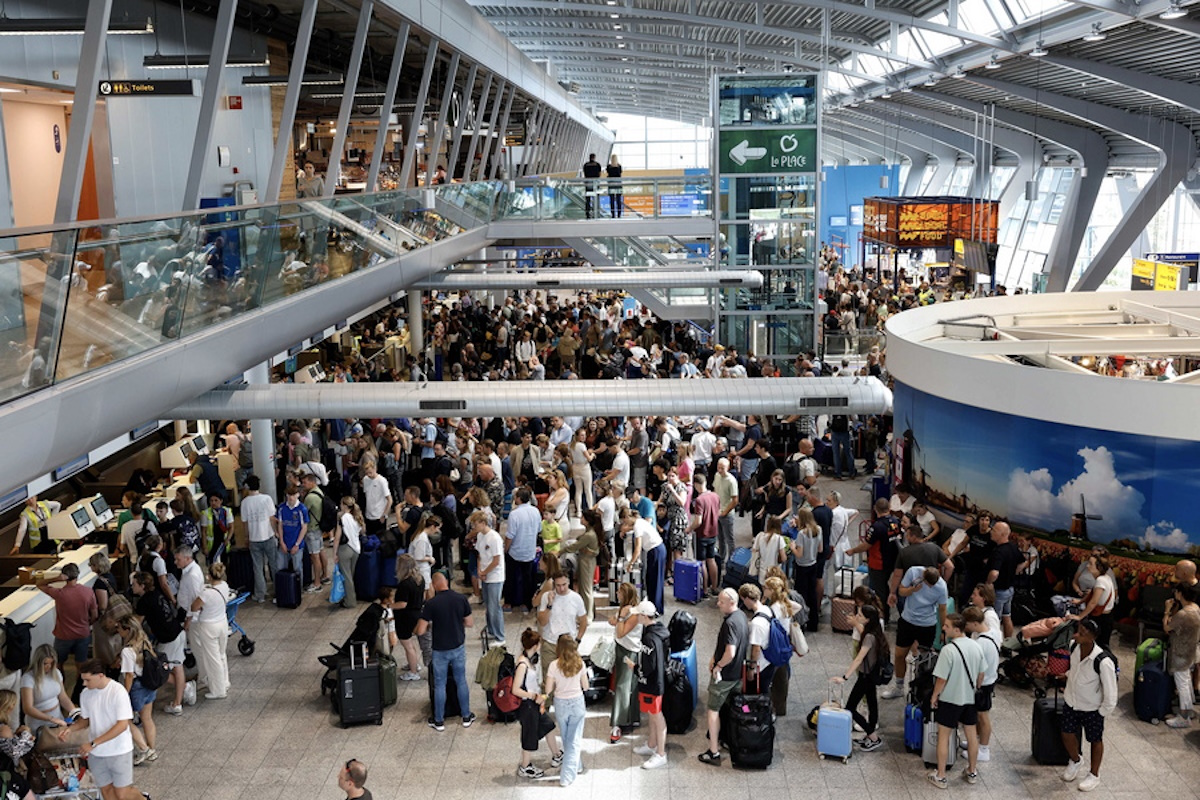 epa11487722 Travelers wait to check in at Eindhoven Airport during a global tech outage in Eindhoven, the Netherlands, 19 July 2024. Companies and institutions around the world have been affected on 19 July by a major computer outage in systems running Microsoft Windows linked to a faulty Crowdstrike cyber-security software update. Several airports and airlines around the world have reported issues with their IT systems on 19 July, due to the outage.  EPA