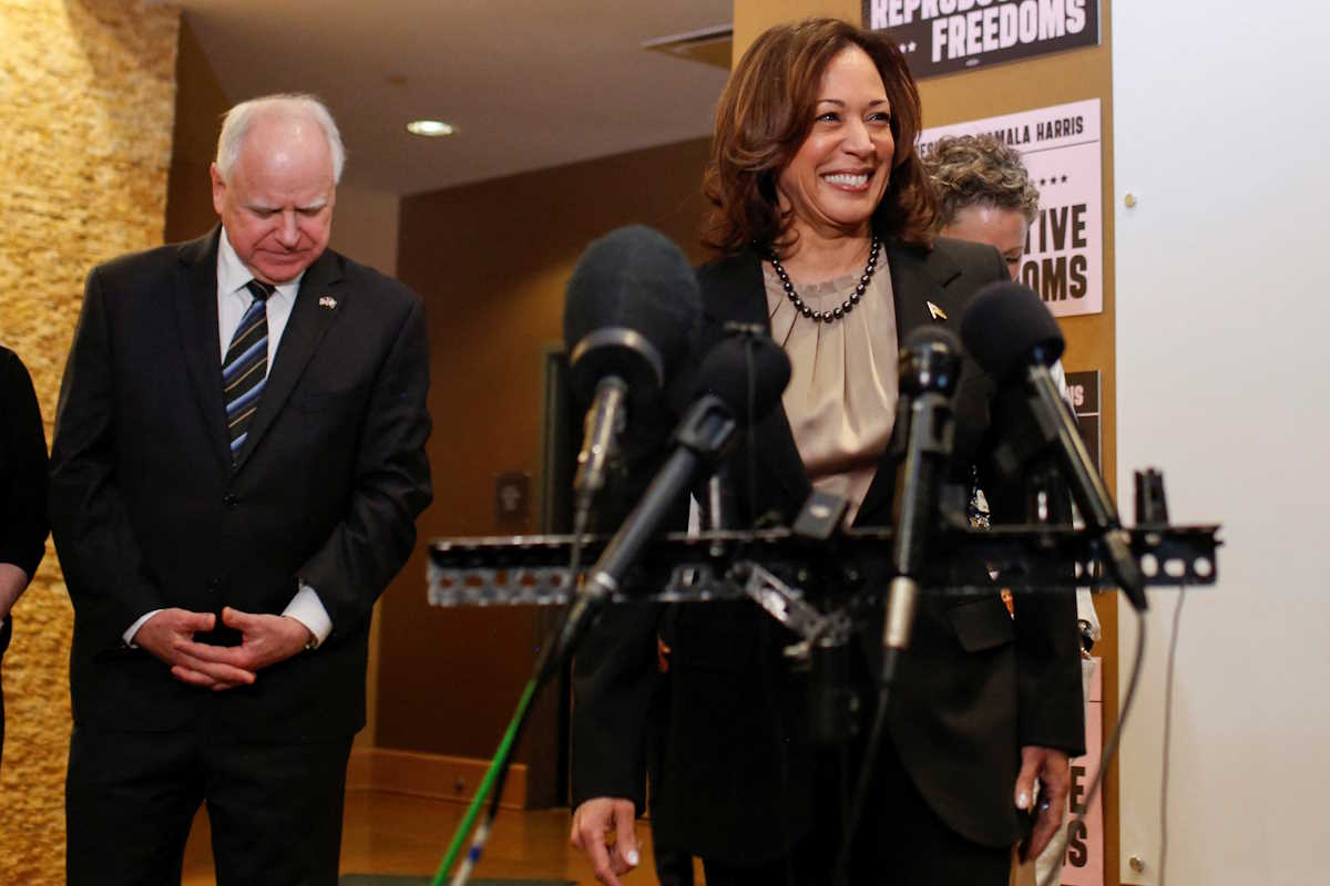 U.S. Vice President Kamala Harris speaks next to Minnesota Governor Tim Walz during a visit to the St. Paul Health Center, a clinic that performs abortions, in St. Paul, Minnesota, U.S., March 14, 2024. REUTERS