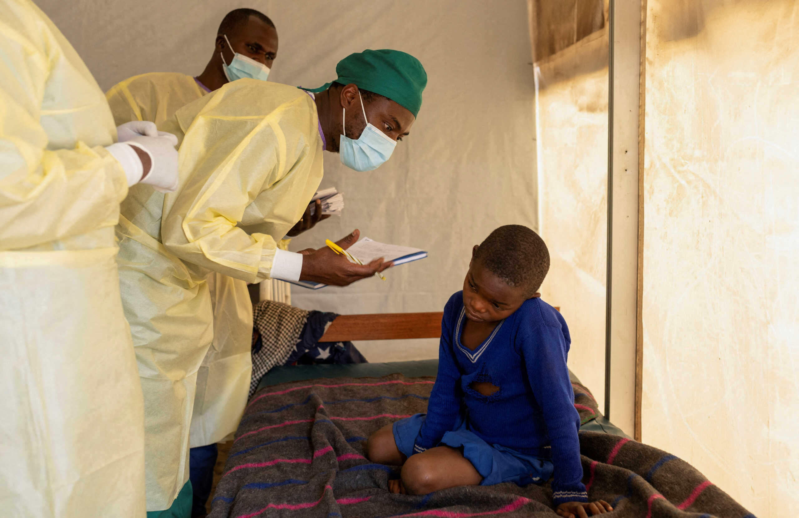 FILE PHOTO: Dr. Tresor Wakilongo, verifies the evolution of skin lesions on the ear of Innocent, suffering from Mpox - an infectious disease caused by the monkeypox virus that sparks off a painful rash, enlarged lymph nodes and fever; at the treatment centre in Munigi, following Mpox cases in Nyiragongo territory near Goma, North Kivu province, Democratic Republic of the Congo July 19, 2024. REUTERS