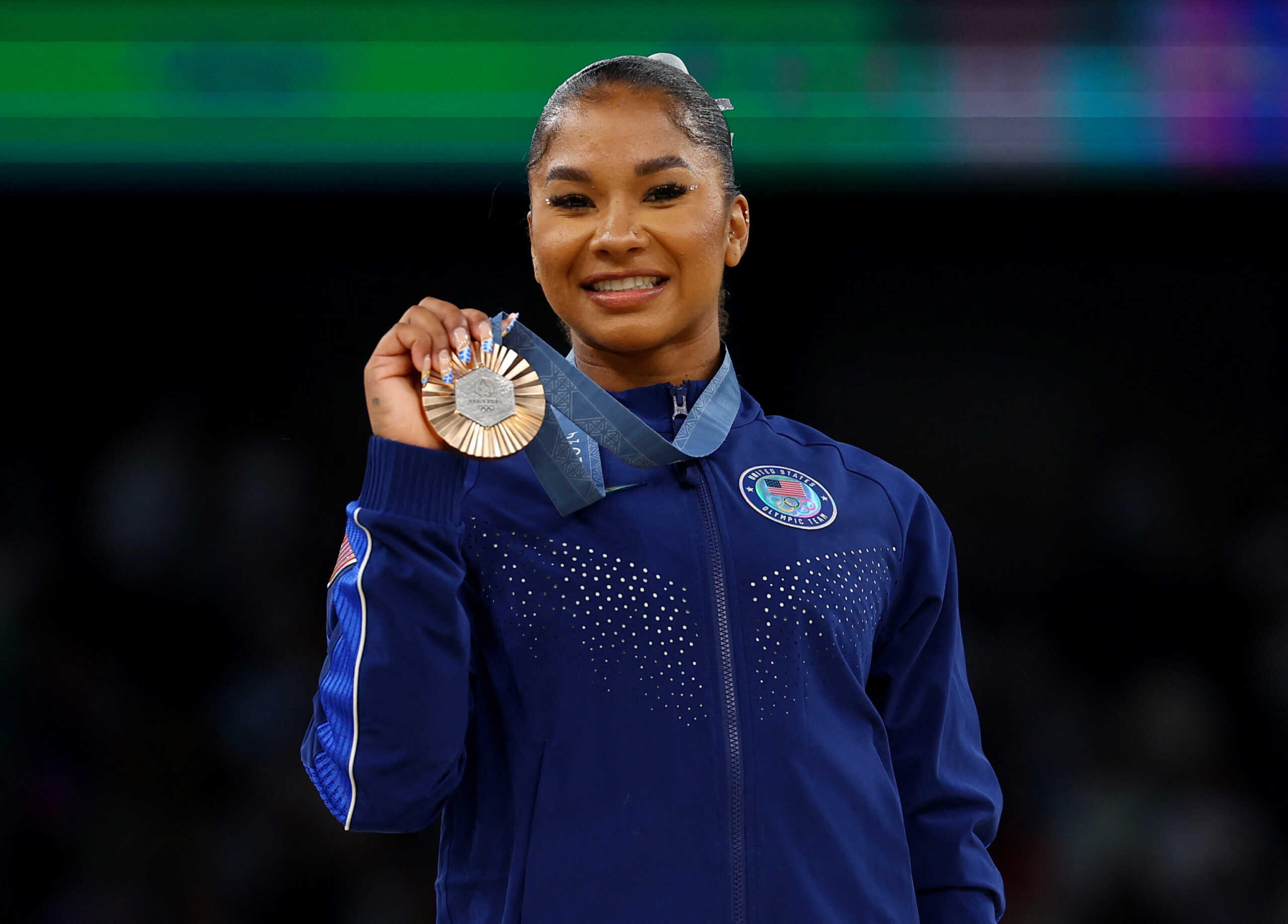 Paris 2024 Olympics - Artistic Gymnastics - Women's Floor Exercise Victory Ceremony - Bercy Arena, Paris, France - August 05, 2024. Bronze medallist Jordan Chiles of United States celebrates on the podium with her medal. REUTERS