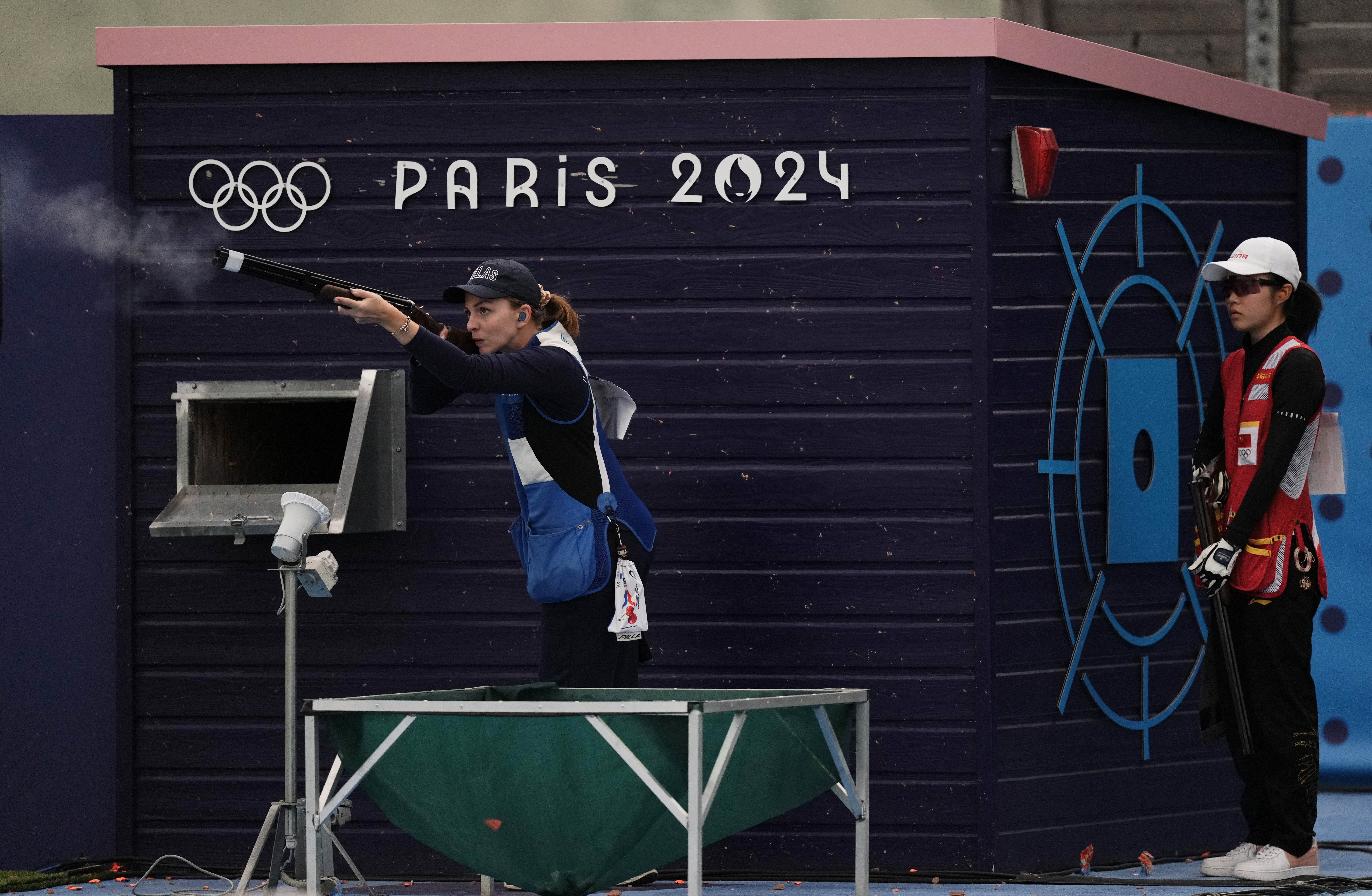 Paris 2024 Olympics - Shooting - Skeet Women's Qualification - Day 2 - Chateauroux Shooting Centre, Deols, France - August 04, 2024. Emmanouela Katzouraki of Greece in action next to Yiting Jiang of China. REUTERS