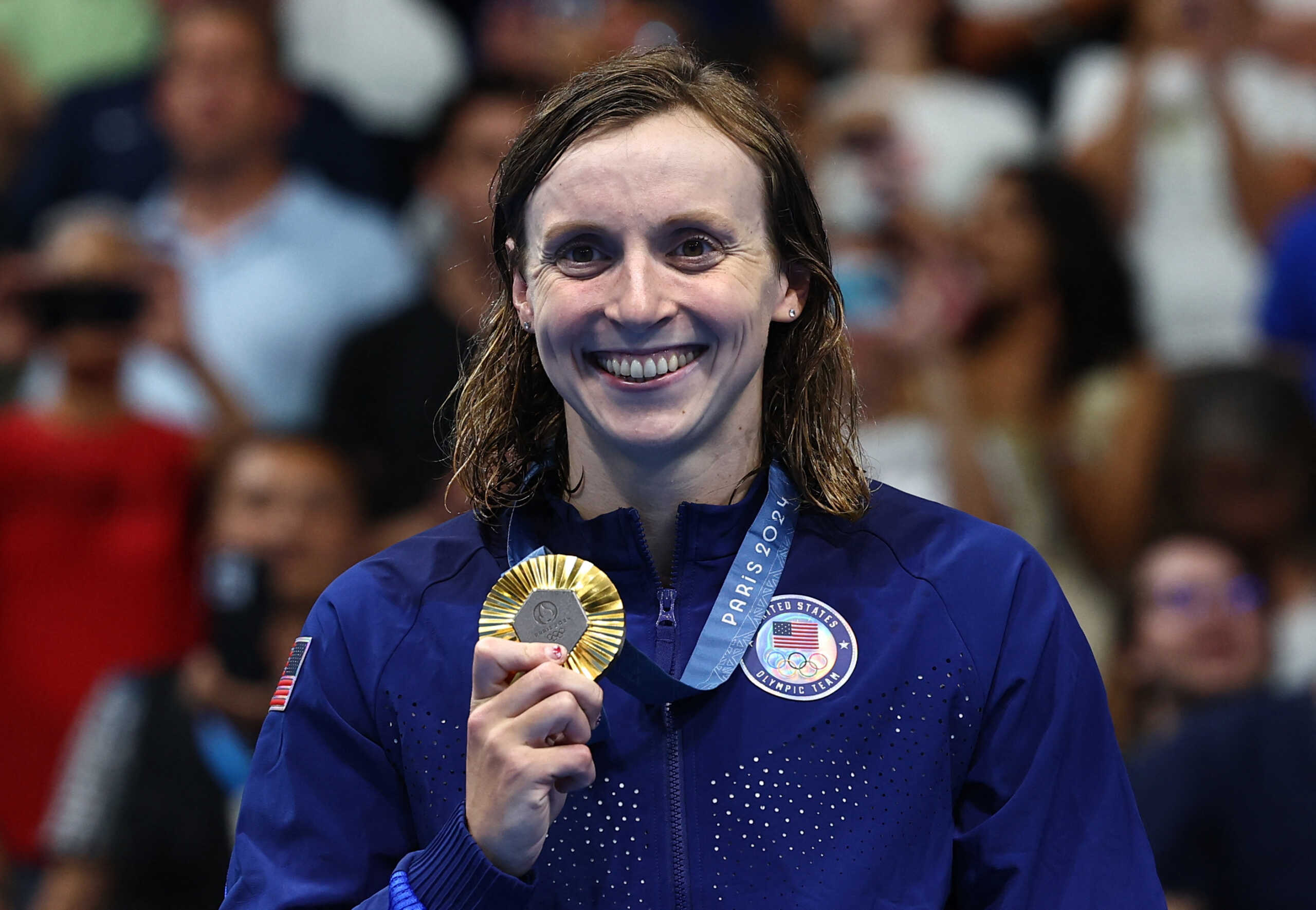 Paris 2024 Olympics - Swimming - Women's 800m Freestyle Victory Ceremony - Paris La Defense Arena, Nanterre, France - August 03, 2024. Gold medallist Katie Ledecky of United States celebrates on the podium after winning. REUTERS