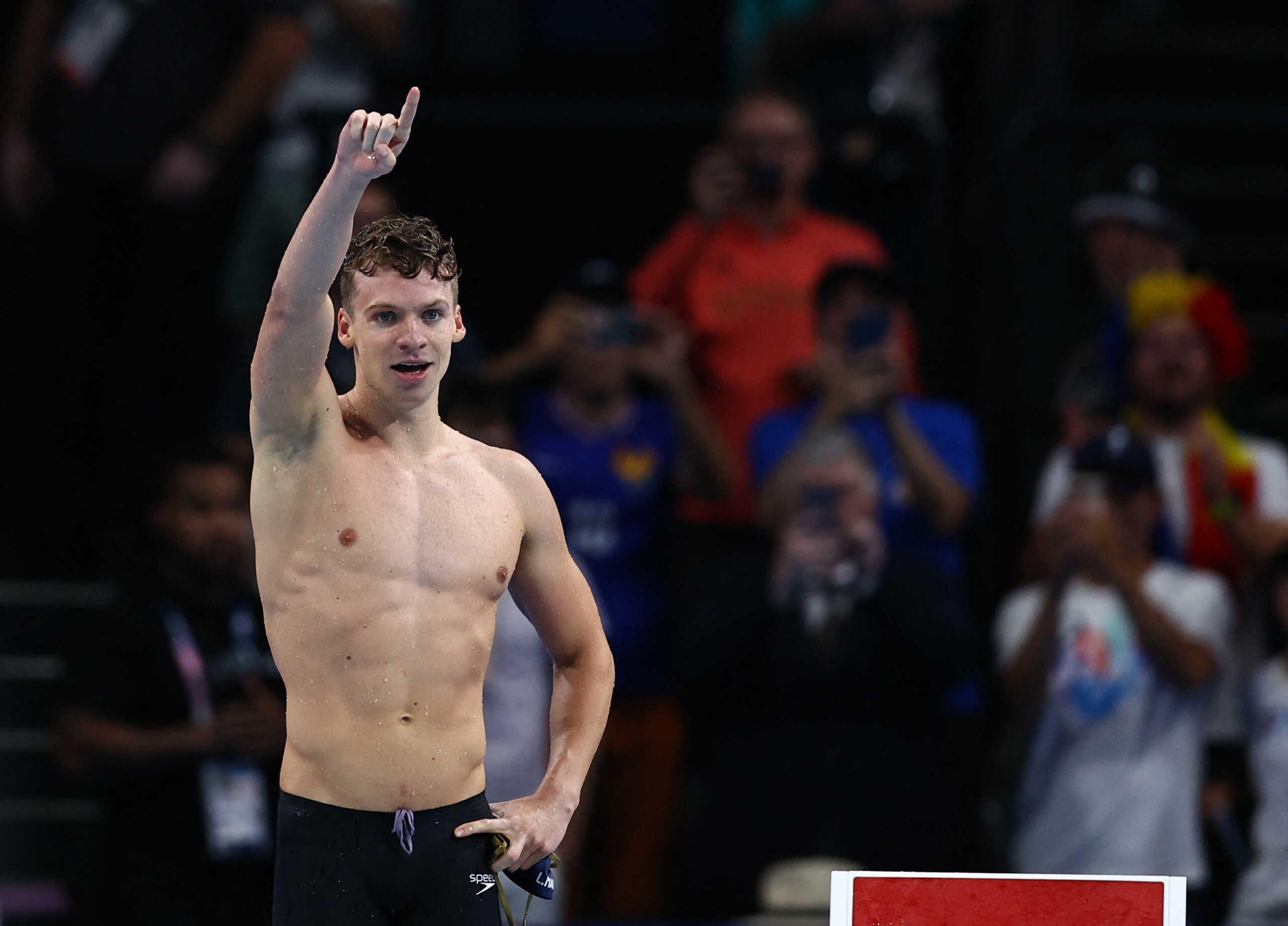 Paris 2024 Olympics - Swimming - Men's 200m Breaststroke Final - Paris La Defense Arena, Nanterre, France - July 31, 2024. Leon Marchand of France reacts after winning the race and establishing Olympic record. REUTERS