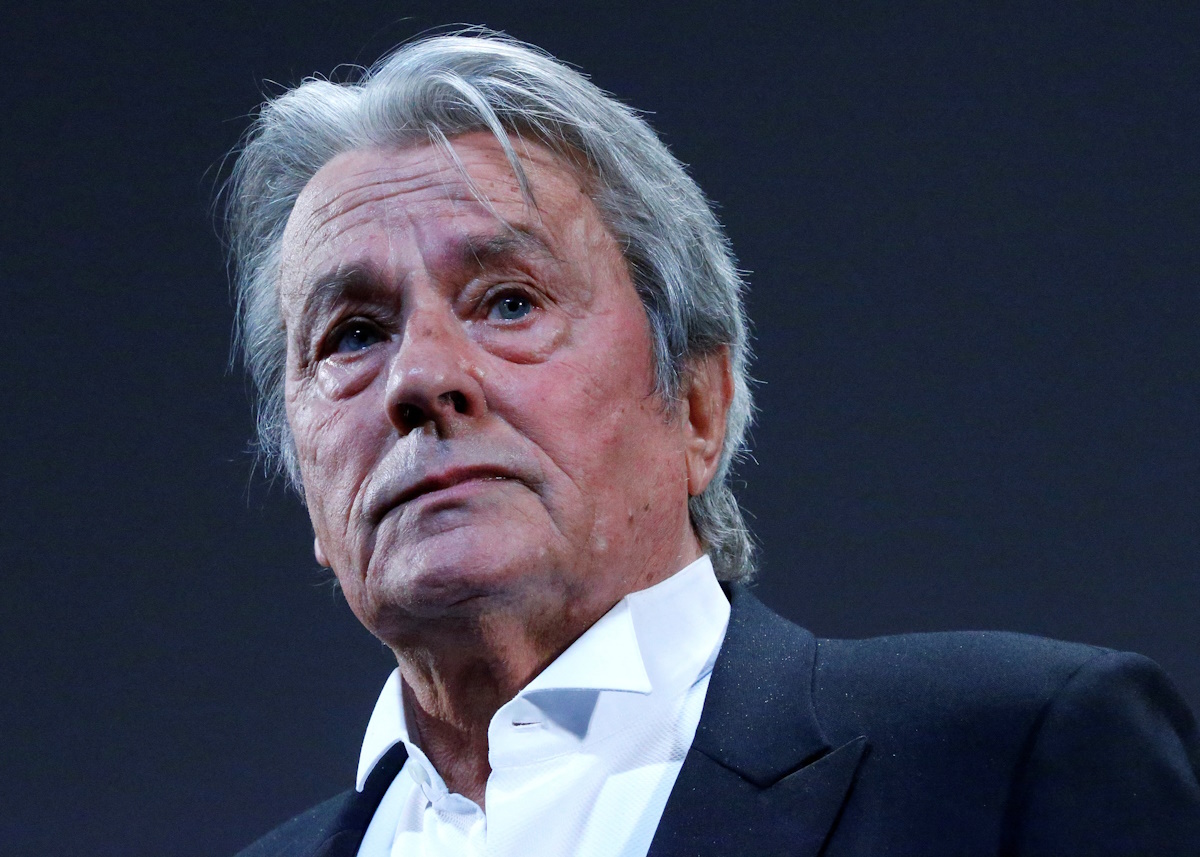 FILE PHOTO: Actor Alain Delon salutes on stage during a tribute for his career before the screening of the restored print of the film "Plein Soleil" by Rene Clement during the 66th Cannes Film Festival in Cannes May 25, 2013. REUTERS