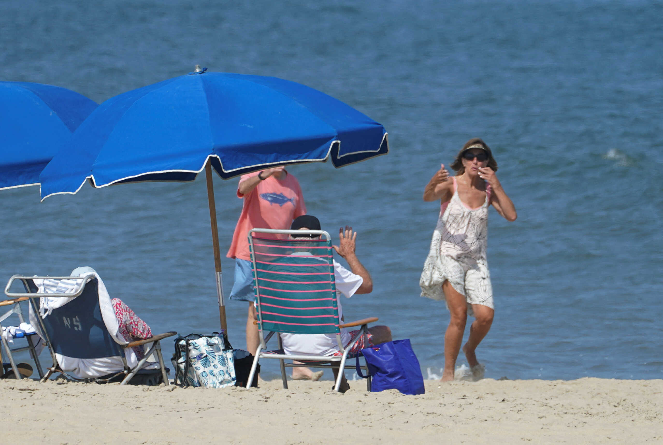 A woman blows kisses to U.S. President Joe Biden, who waves back, on the beach in Rehoboth, Delaware, U.S., August 28, 2024. REUTERS