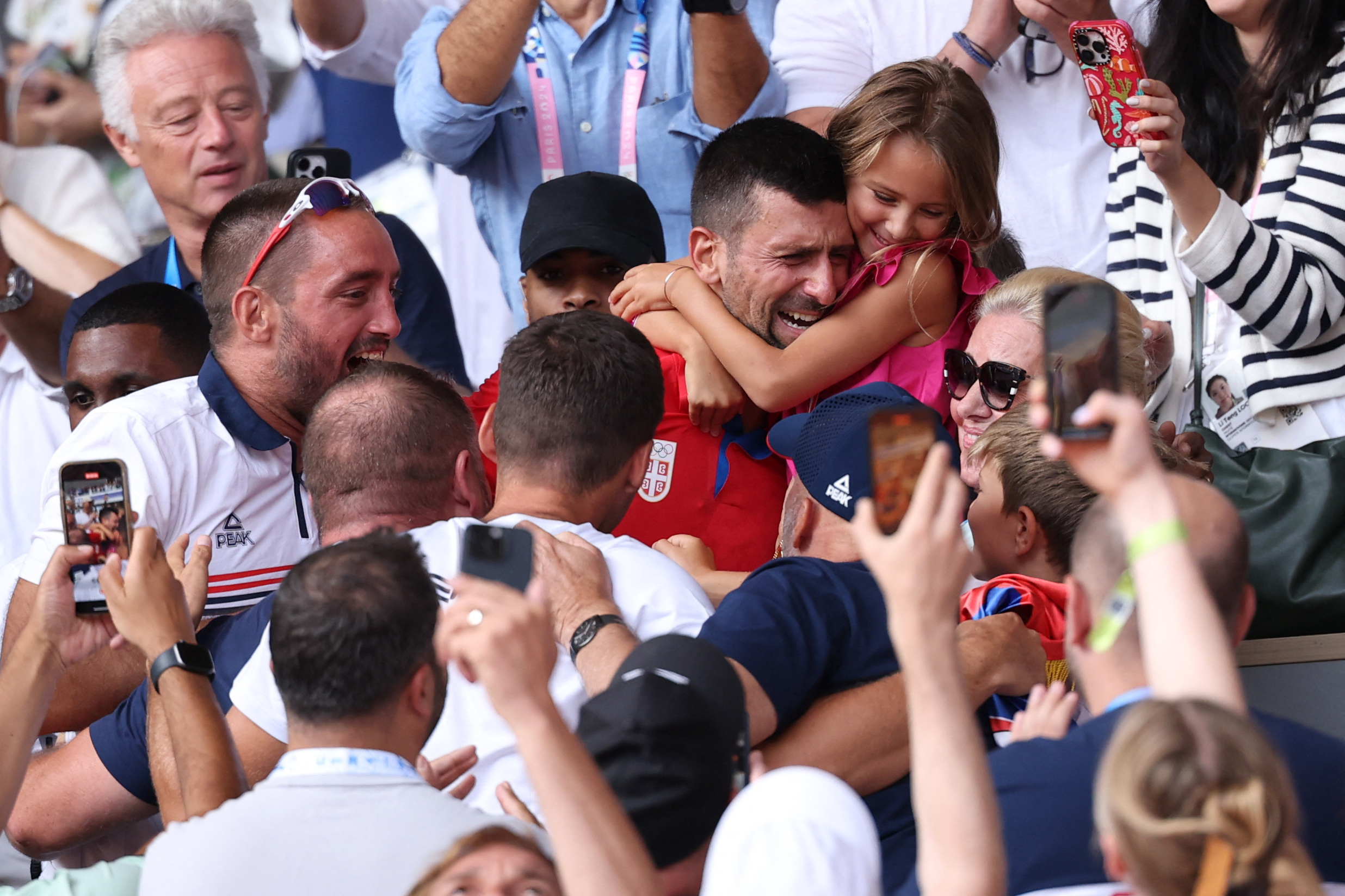 Paris 2024 Olympics - Tennis - Men's Singles Gold Medal Match - Roland-Garros Stadium, Paris, France - August 04, 2024. Novak Djokovic of Serbia celebrates with his family after winning gold against Carlos Alcaraz of Spain. REUTERS