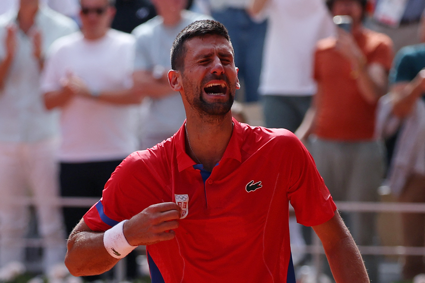 Paris 2024 Olympics - Tennis - Men's Singles Gold Medal Match - Roland-Garros Stadium, Paris, France - August 04, 2024. Novak Djokovic of Serbia reacts after winning gold against Carlos Alcaraz of Spain. REUTERS