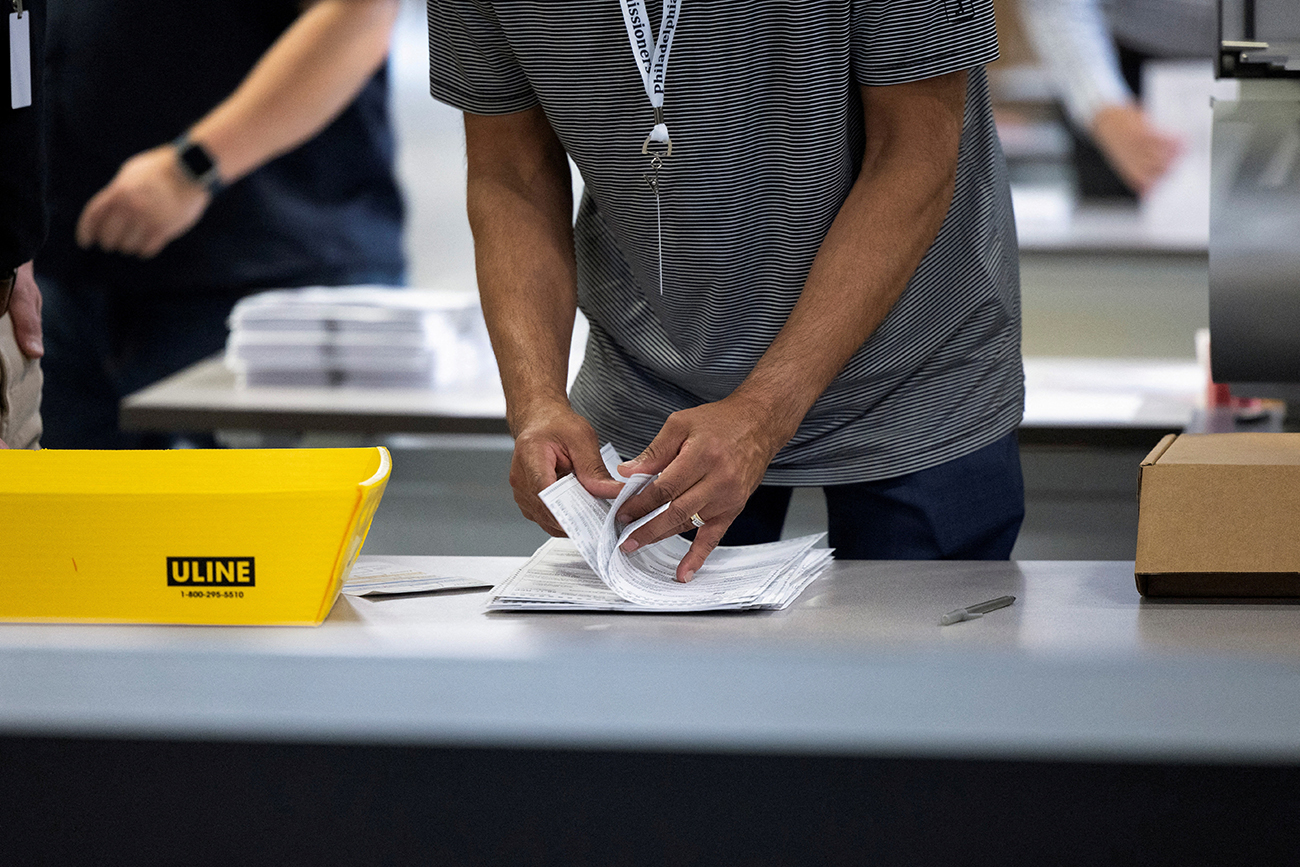 FILE PHOTO: An election worker processes ballots at Philadelphia's vote counting facility on Pennsylvania's primary election day in Philadelphia, Pennsylvania, U.S. April 23, 2024.  REUTERS