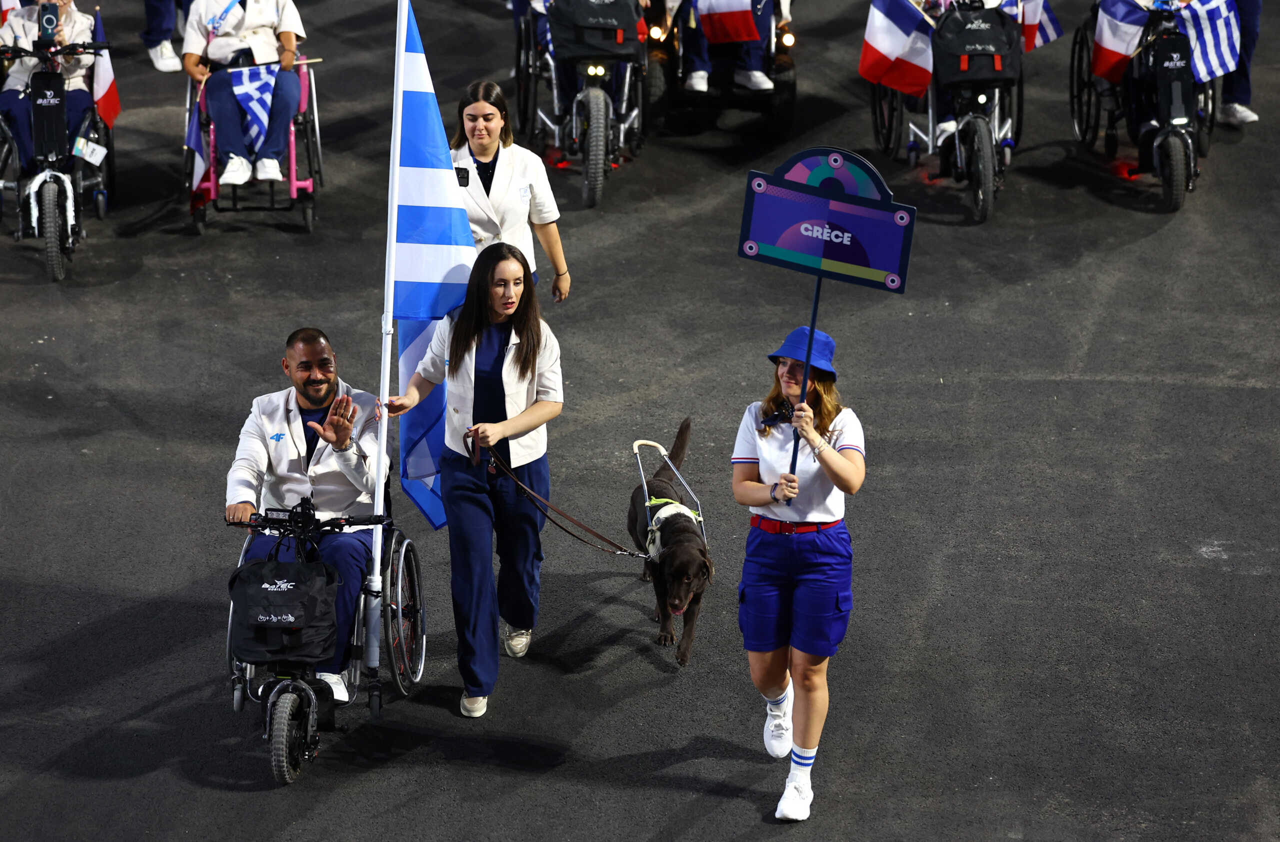 Paris 2024 Paralympics - Opening Ceremony - Paris, France - August 28, 2024 Theodora Paschalidou of Greece and Emmanouil Stefanoudakis of Greece lead their contingent during the opening ceremony REUTERS