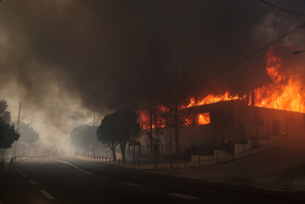 A high school building and its gym are seen in flames as a wildfire burns in Nea Penteli, near Athens, Greece, August 12, 2024. REUTERS