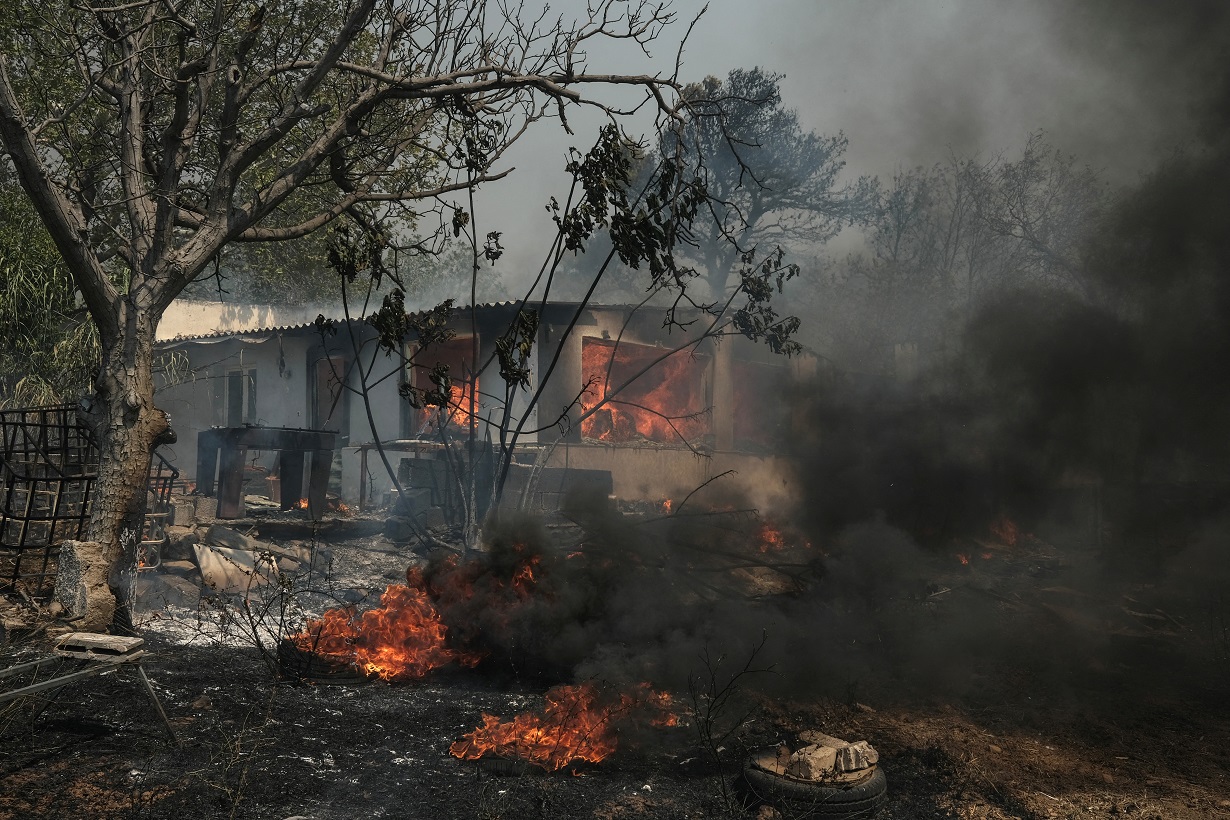 A house is seen in flames as a wildfire burns in Nea Penteli, Greece, August 12, 2024. REUTERS