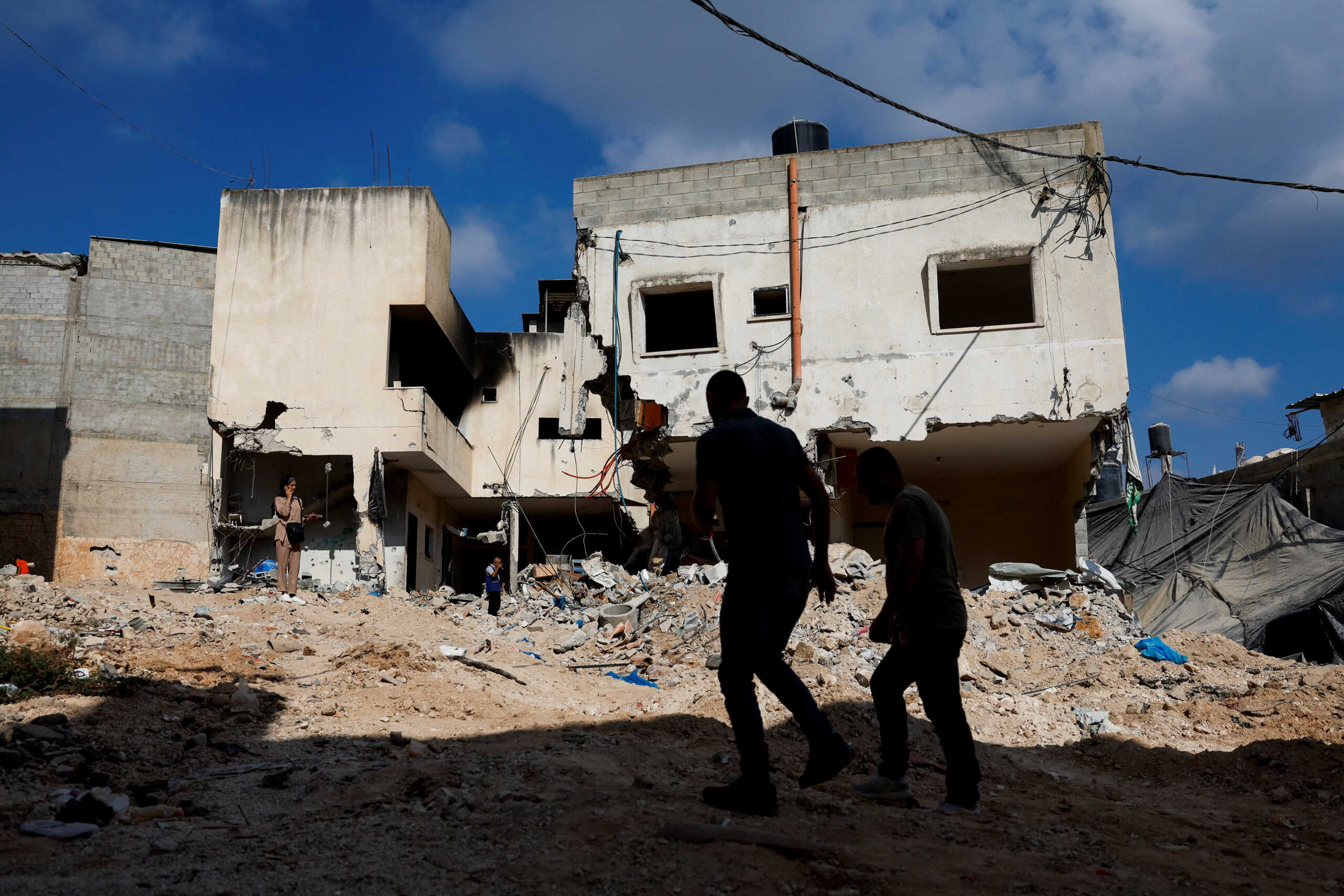 Palestinians walk, following an Israeli military raid, in Tulkarm, in the Israeli-occupied West Bank, August 30, 2024. REUTERS