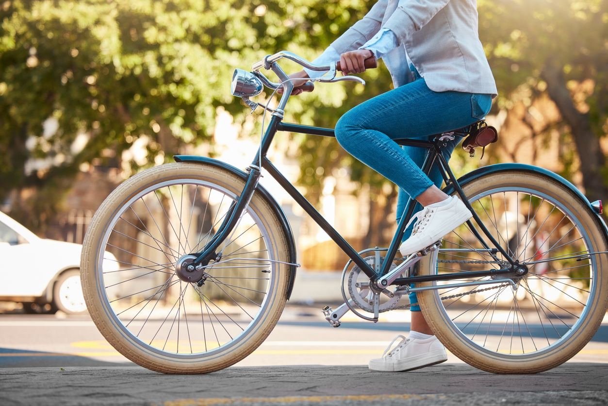 Adventure, street travel and bike break outdoor in urban city in summer. Woman with vintage bicycle in a road for transport. Sustainability person traveling with health mindset or healthy energy