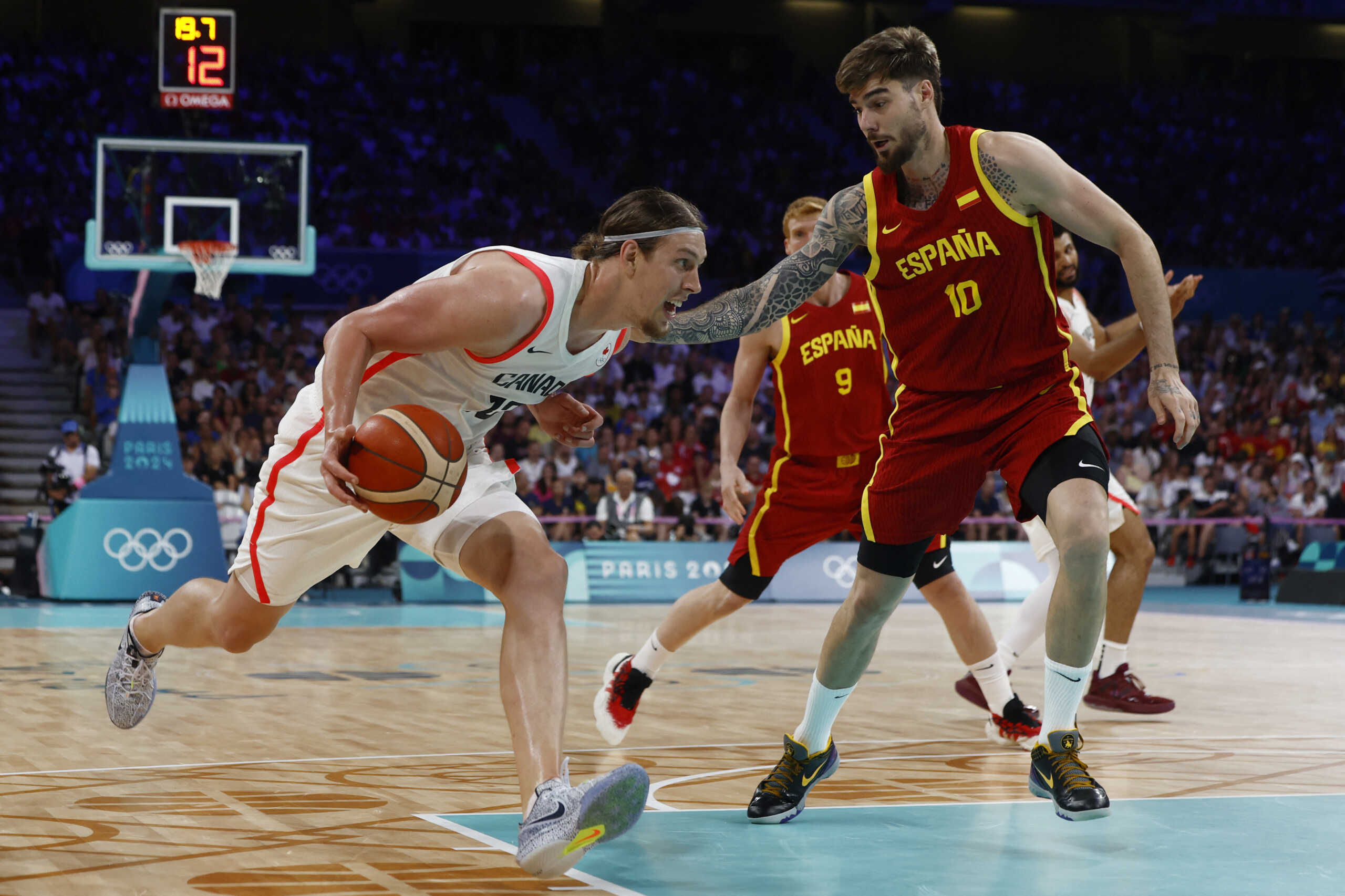 Paris 2024 Olympics - Basketball - Men's Group Phase - Group A - Canada vs Spain - Lille, Pierre Mauroy Stadium, Villeneve-d'Ascq, France - August 02, 2024. Kelly Olynyk of Canada in action against Juancho Hernangomez of Spain REUTERS