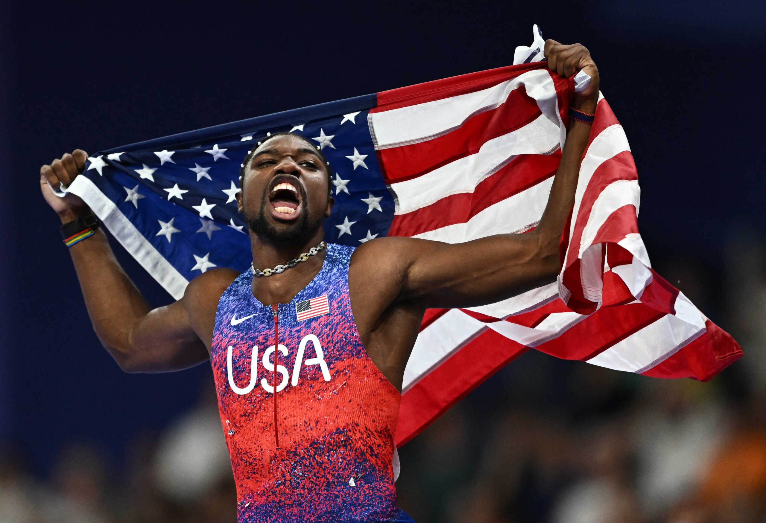 Paris 2024 Olympics - Athletics - Men's 100m Final - Stade de France, Saint-Denis, France - August 04, 2024. Noah Lyles of United States celebrates after winning gold. REUTERS