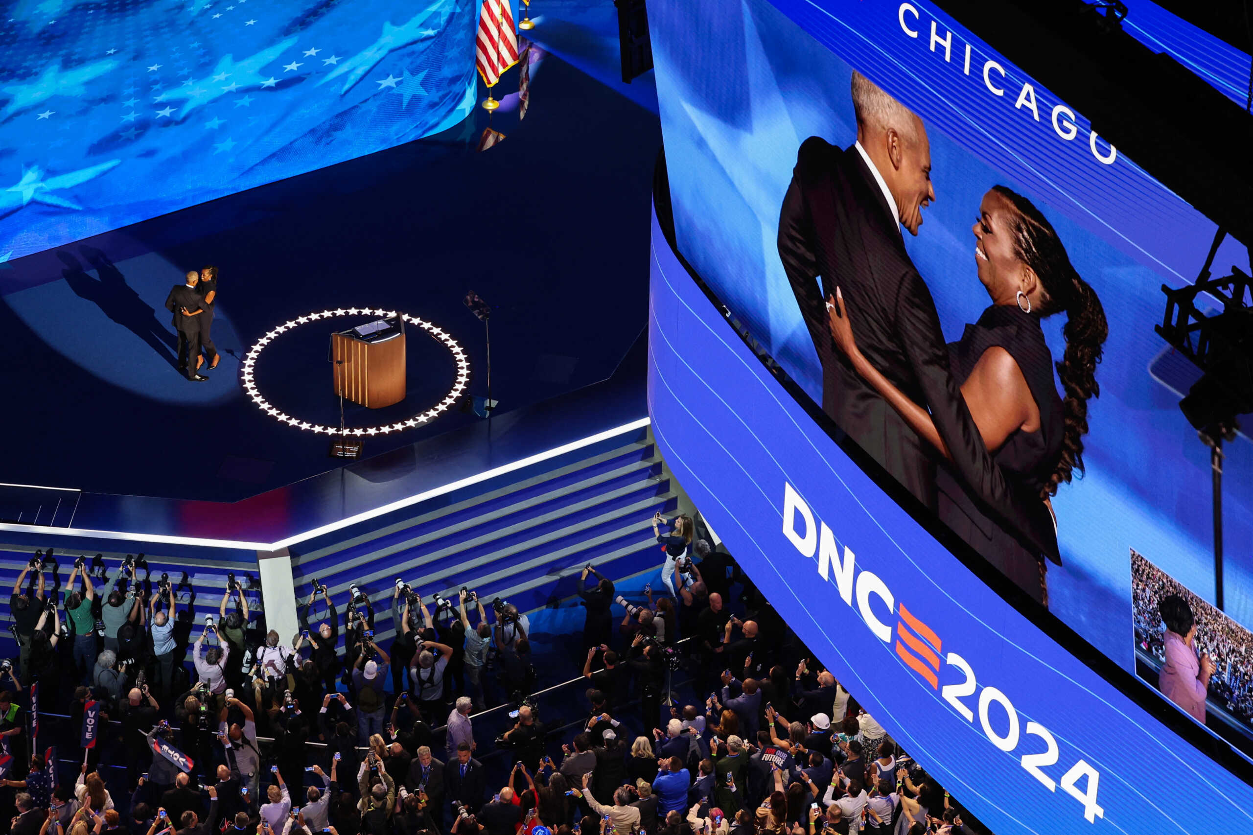 Former U.S. first lady Michelle Obama greets her husband, former U.S. President Barack Obama, on stage before his speech during Day 2 of the Democratic National Convention (DNC) in Chicago, Illinois, U.S., August 20, 2024. REUTERS