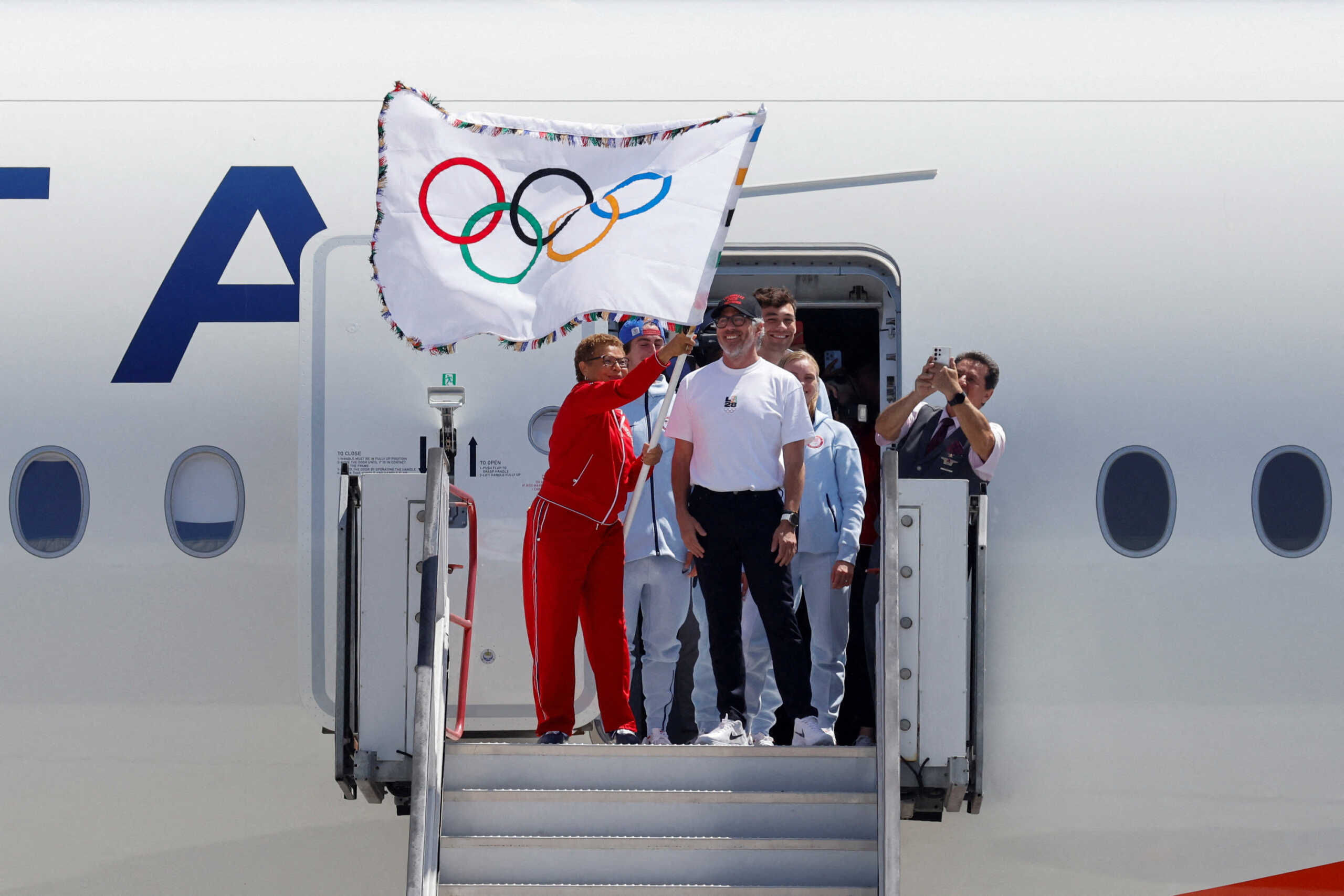 Los Angeles Mayor Karen Bass and LA28 Chairman Casey Wasserman return the official Olympic flag to Los Angeles for the first time in 40 years ahead of the 2028 Games, in Los Angeles, California, U.S. August 12, 2024. REUTERS