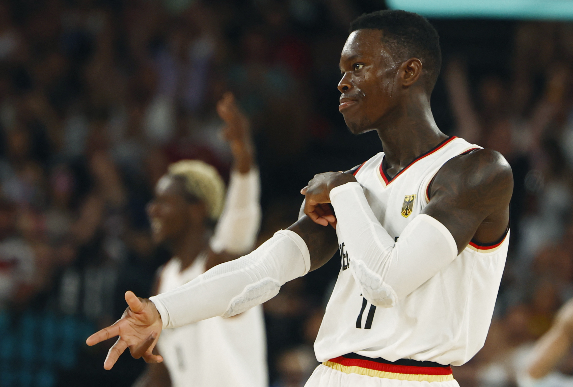 Paris 2024 Olympics - Basketball - Men's Quarterfinal- Germany vs Greece - Bercy Arena, Paris, France - August 06, 2024. Dennis Schroder of Germany celebrates after scoring a three-point basket REUTERS