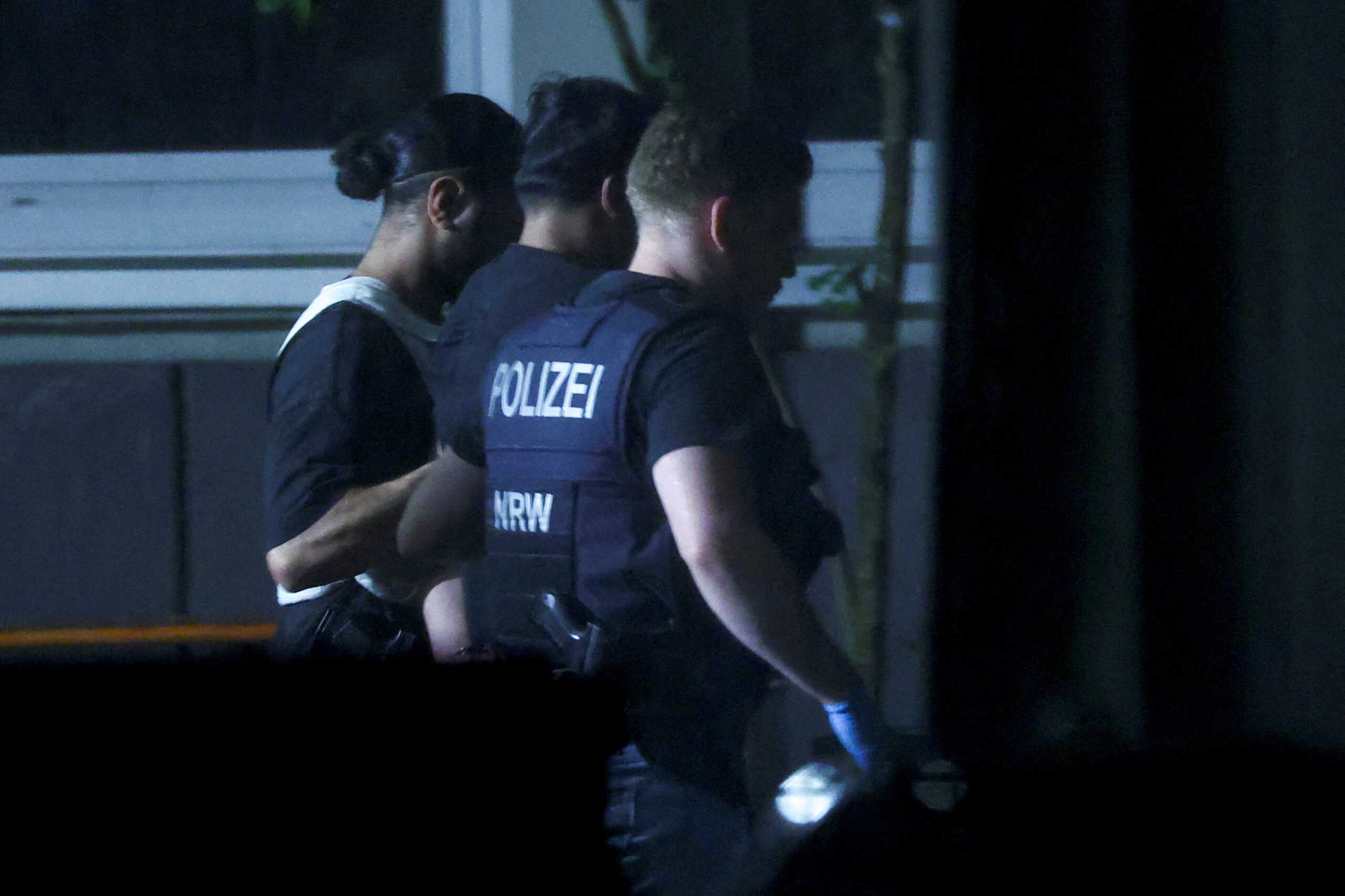 Police officers detain a person, following an incident in which several individuals were killed after a man randomly stabbed passers-by with a knife at a city festival, in Solingen, Germany, August 24, 2024. REUTERS