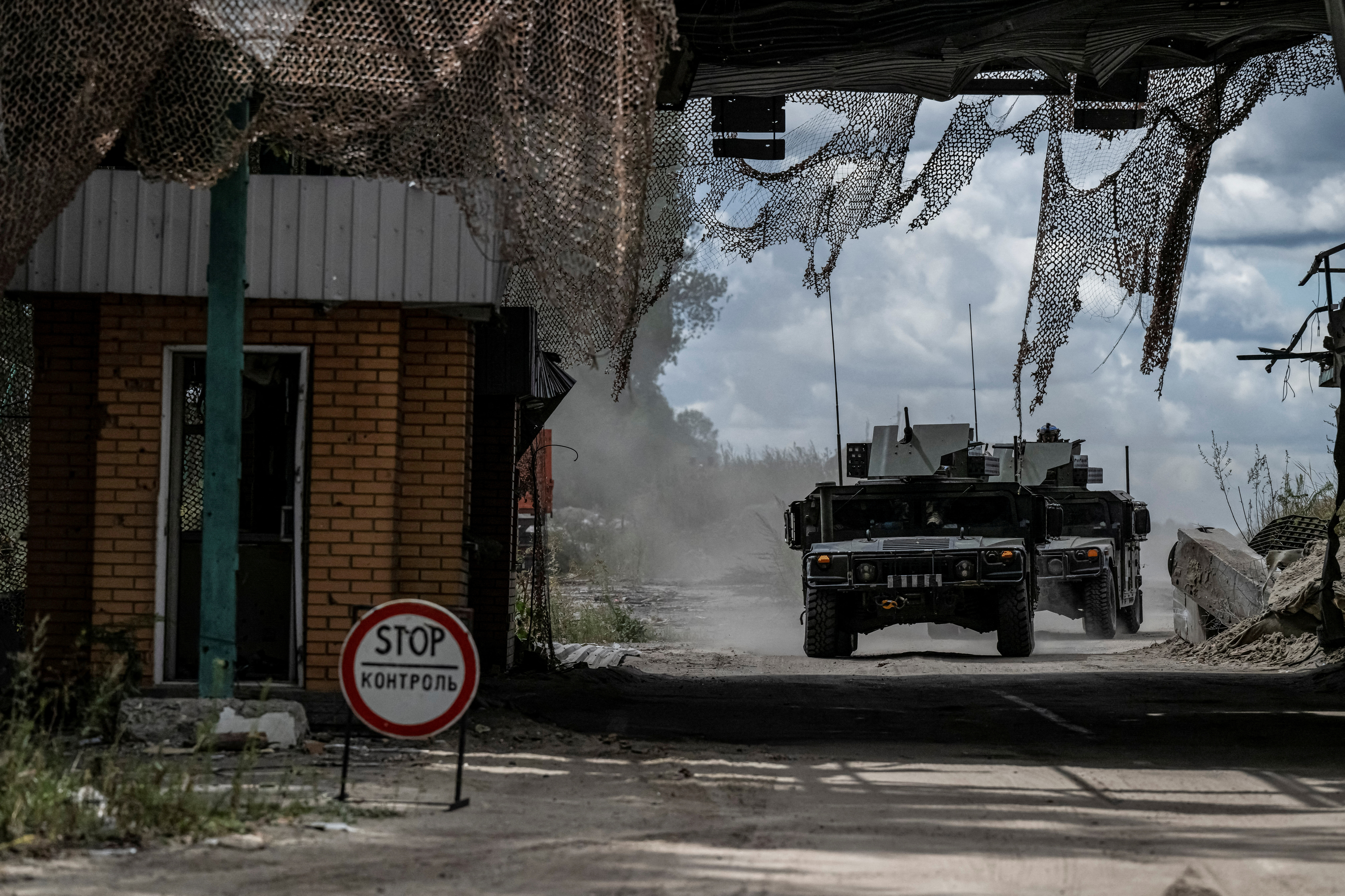 Ukrainian servicemen ride military vehicles from a crossing point at the border with Russia, amid Russia's attack on Ukraine, in Sumy region, Ukraine August 13, 2024. REUTERS