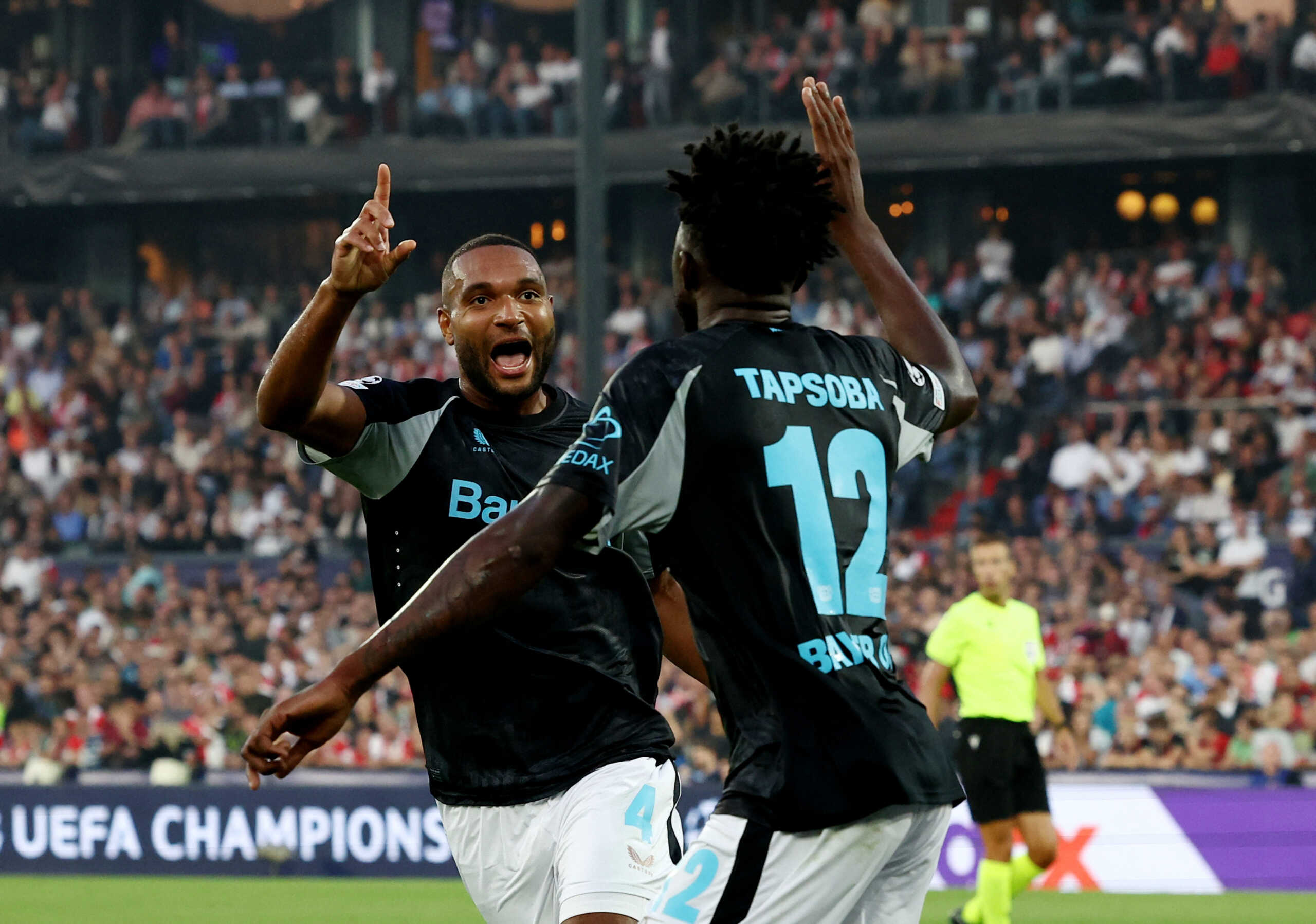 Soccer Football - Champions League - Feyenoord v Bayer Leverkusen - Feyenoord Stadium, Rotterdam, Netherlands - September 19, 2024 Bayer Leverkusen's Edmond Tapsoba celebrates scoring their fourth goal with Jonathan Tah REUTERS