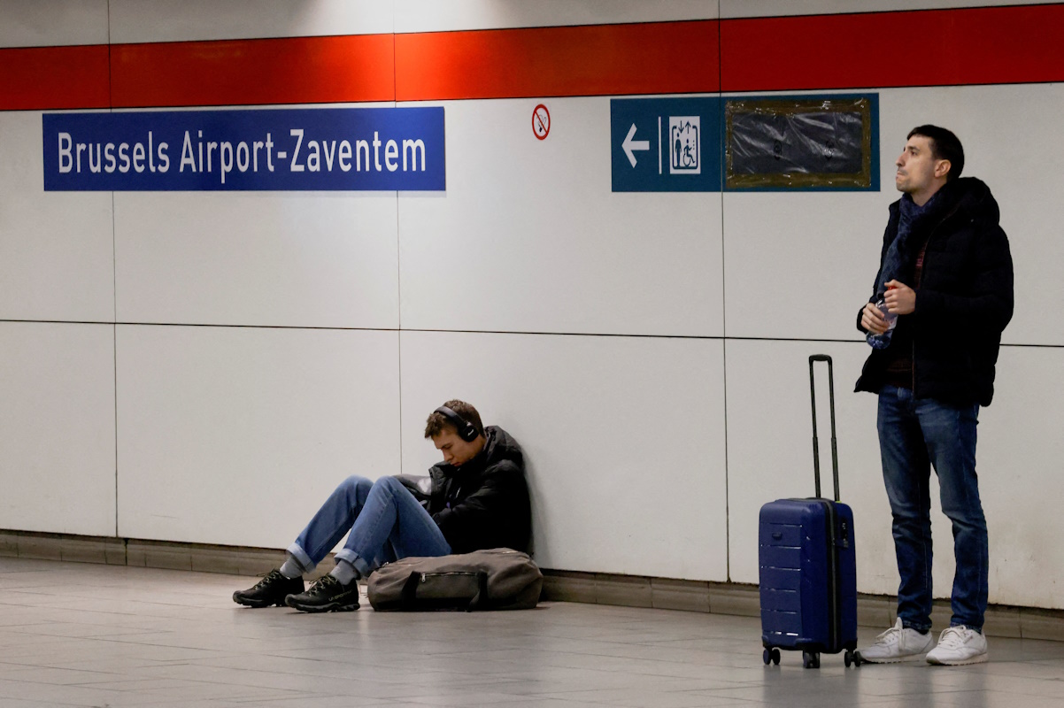 FILE PHOTO: Passengers wait for one of the few trains at a Brussels Airport train station during a national strike, in Zaventem near Brussels, Belgium November 9, 2022. REUTERS