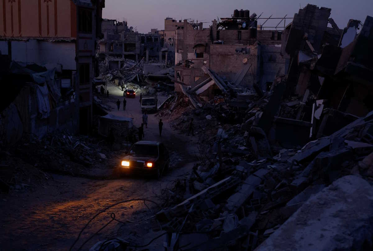 Cars drive amidst the rubble of buildings destroyed after an Israeli strike, amid the ongoing conflict between Israel and Hamas, in Khan Younis, in the southern Gaza Strip September 1, 2024. REUTERS