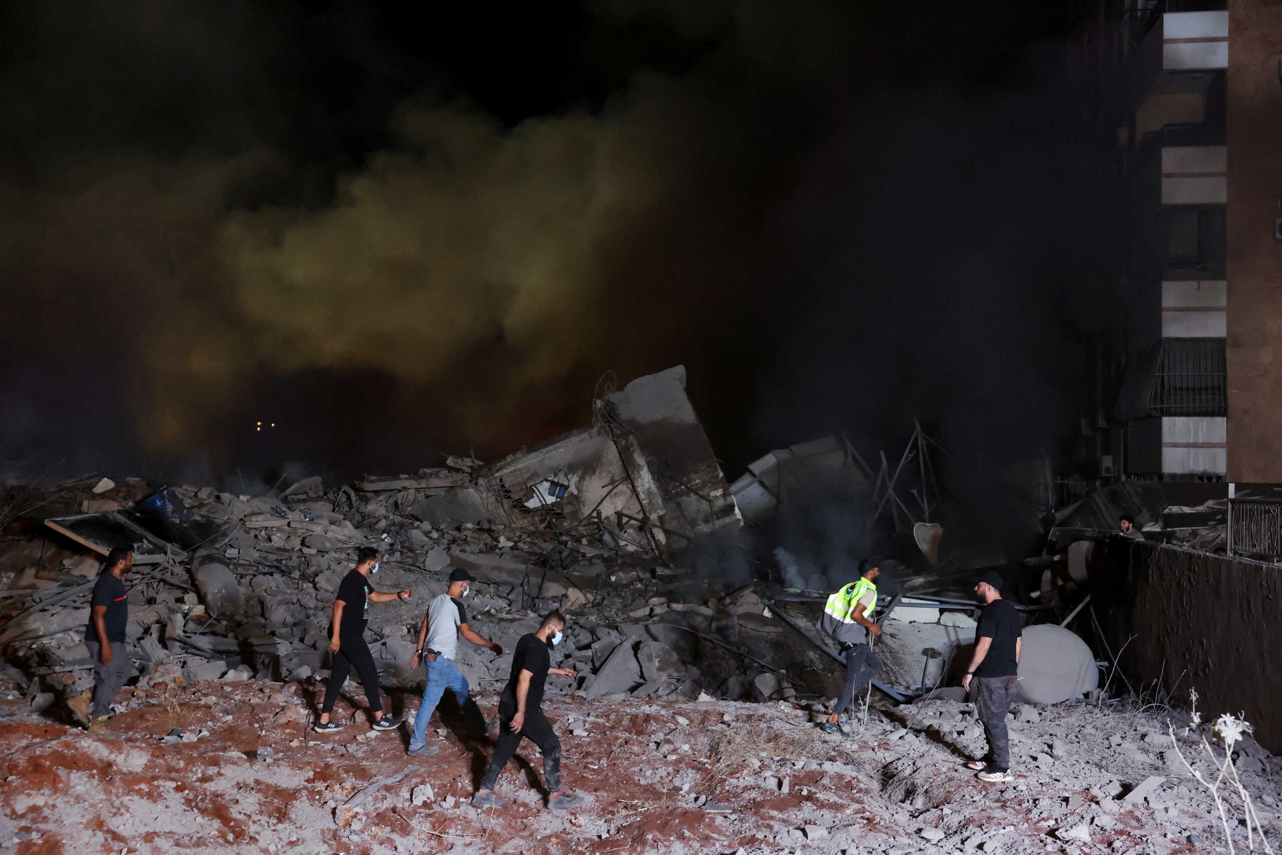 People inspect damage at the site of an Israeli strike, amid ongoing hostilities between Hezbollah and Israeli forces, in Beirut's southern suburbs, Lebanon September 27, 2024. REUTERS