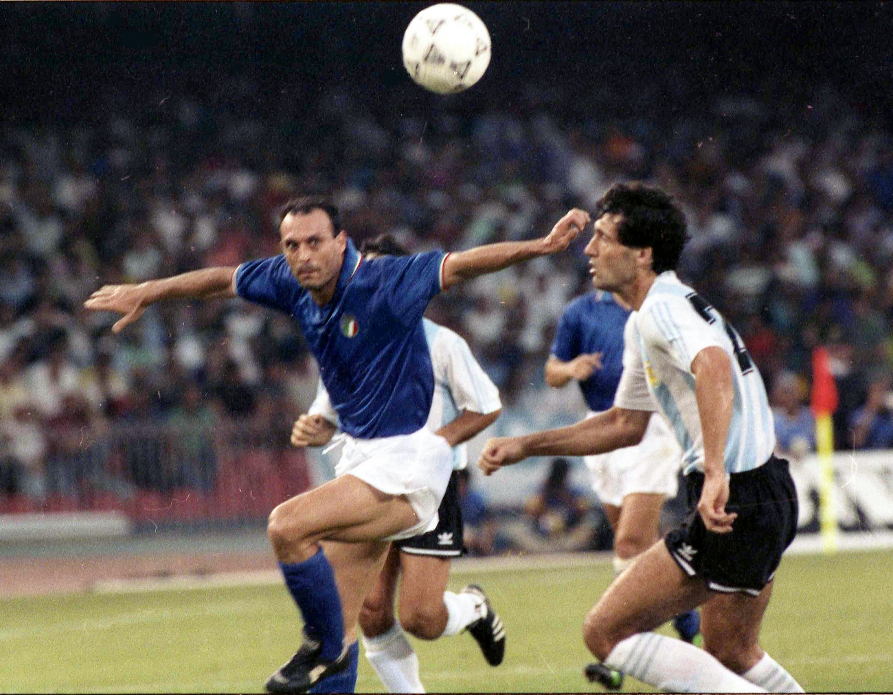 Italy's Salvatore Schillaci, left, and Argentina's Juan Simon chase the ball during the  Soccer World Cup semi-final, in Naples, Italy, July 3, 1990. Argentina and Italy drew one all after extra and Argentina won the match in a penalty shoot-out. (AP Photo)