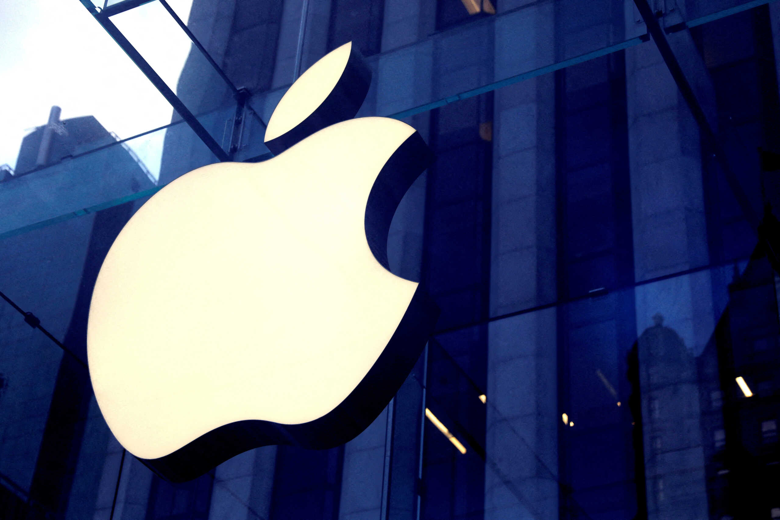 FILE PHOTO: The Apple Inc. logo is seen hanging at the entrance to the Apple store on 5th Avenue in Manhattan, New York, U.S., October 16, 2019. REUTERS