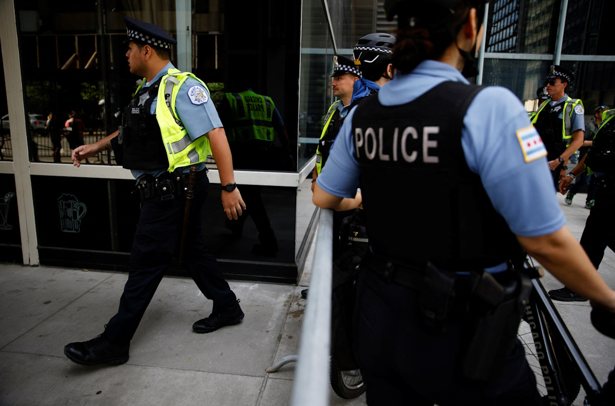 Police officers arrive to provide security as a protest is planned at the Israeli consulate, during the Democratic National Convention (DNC), in Chicago, Illinois, U.S., August 20, 2024. REUTERS