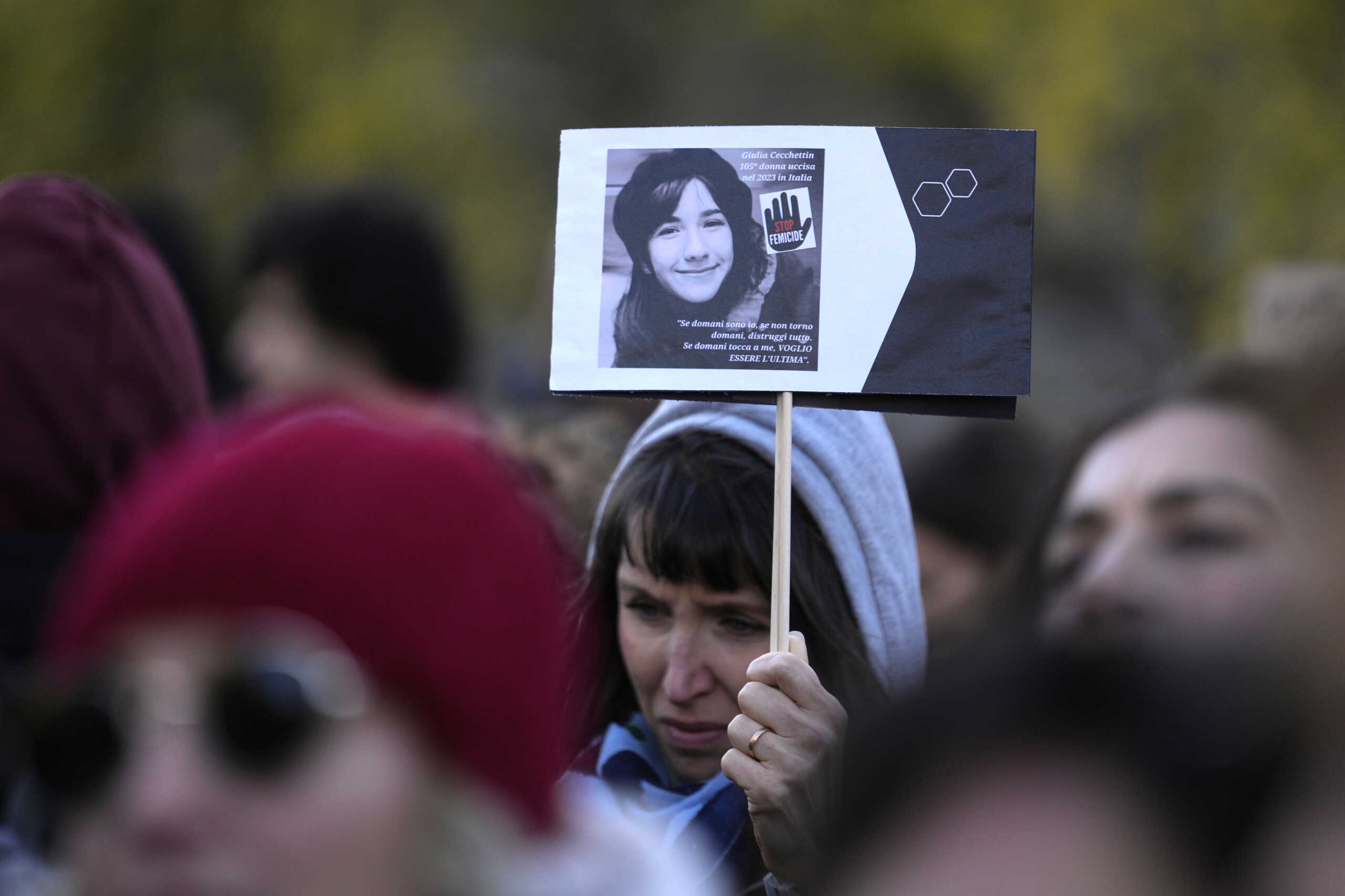 A woman shows a photo of Giulia Cecchettin, allegedly killed by ex-boyfriend, on the occasion of International Day for the Elimination of Violence against Women, in Milan, Italy, Saturday, Nov.25, 2023. Thousands of people are expected to take the streets in Rome and other major Italian cities as part of what organizers call a "revolution" under way in Italians' approach to violence against women, a few days after the horrifying killing of Giulia, the college student allegedly by her resentful ex-boyfriend sparked an outcry over the country's "patriarchal" culture. (AP Photo