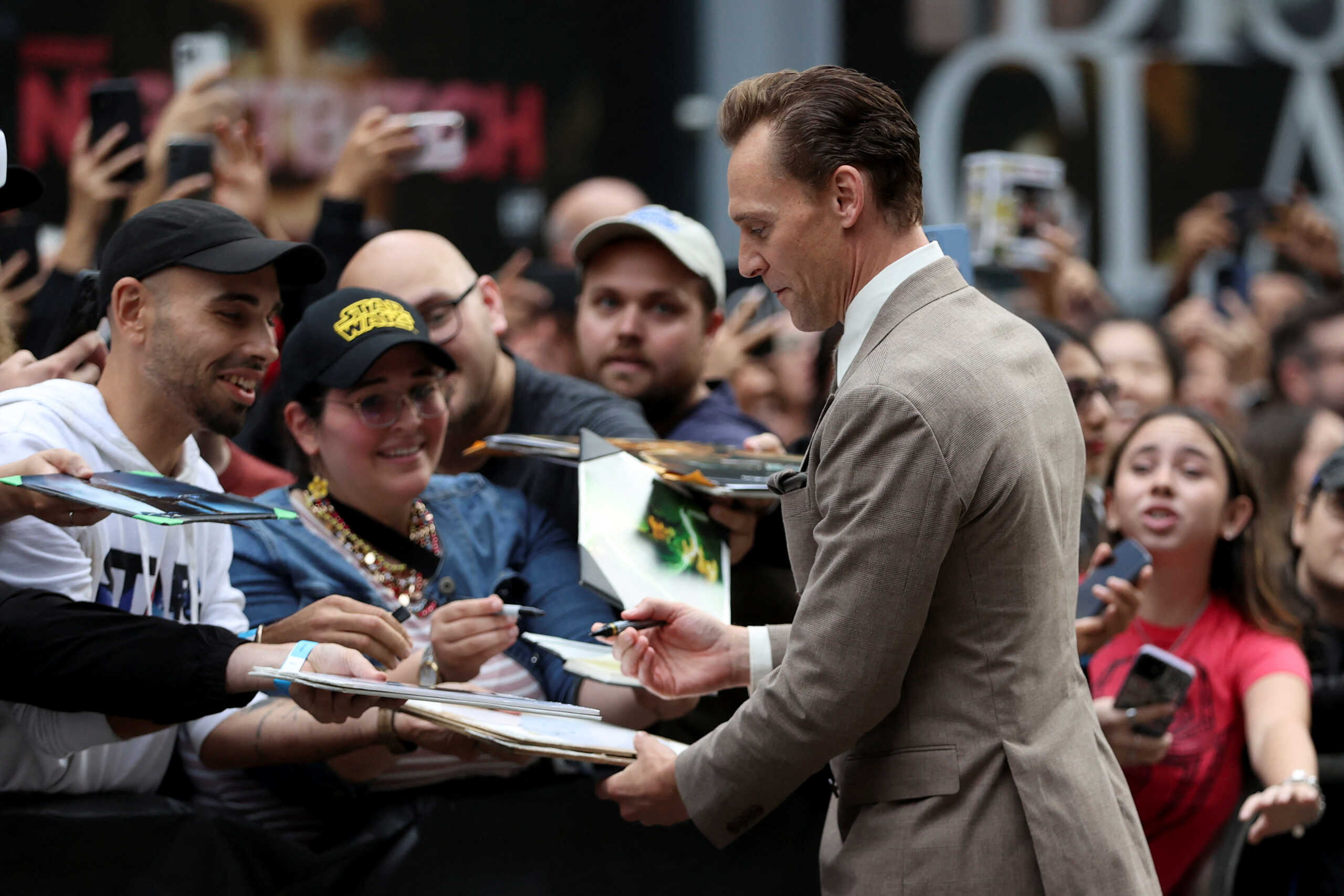 Tom Hiddleston signs autographs on the red carpet before "The Life of Chuck" is screened, as the Toronto International Film Festival (TIFF) returns for its 49th edition in Toronto, Ontario, Canada, September 6, 2024. REUTERS