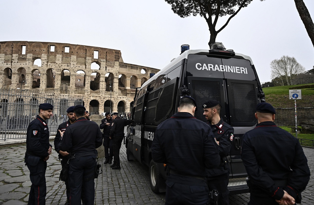 epa11249846 Carabinieri officers stand guard outside the Colosseum prior to the Via Crucis procession led by the Pope, on Holy Friday in Rome, Italy, 29 March 2024.  EPA