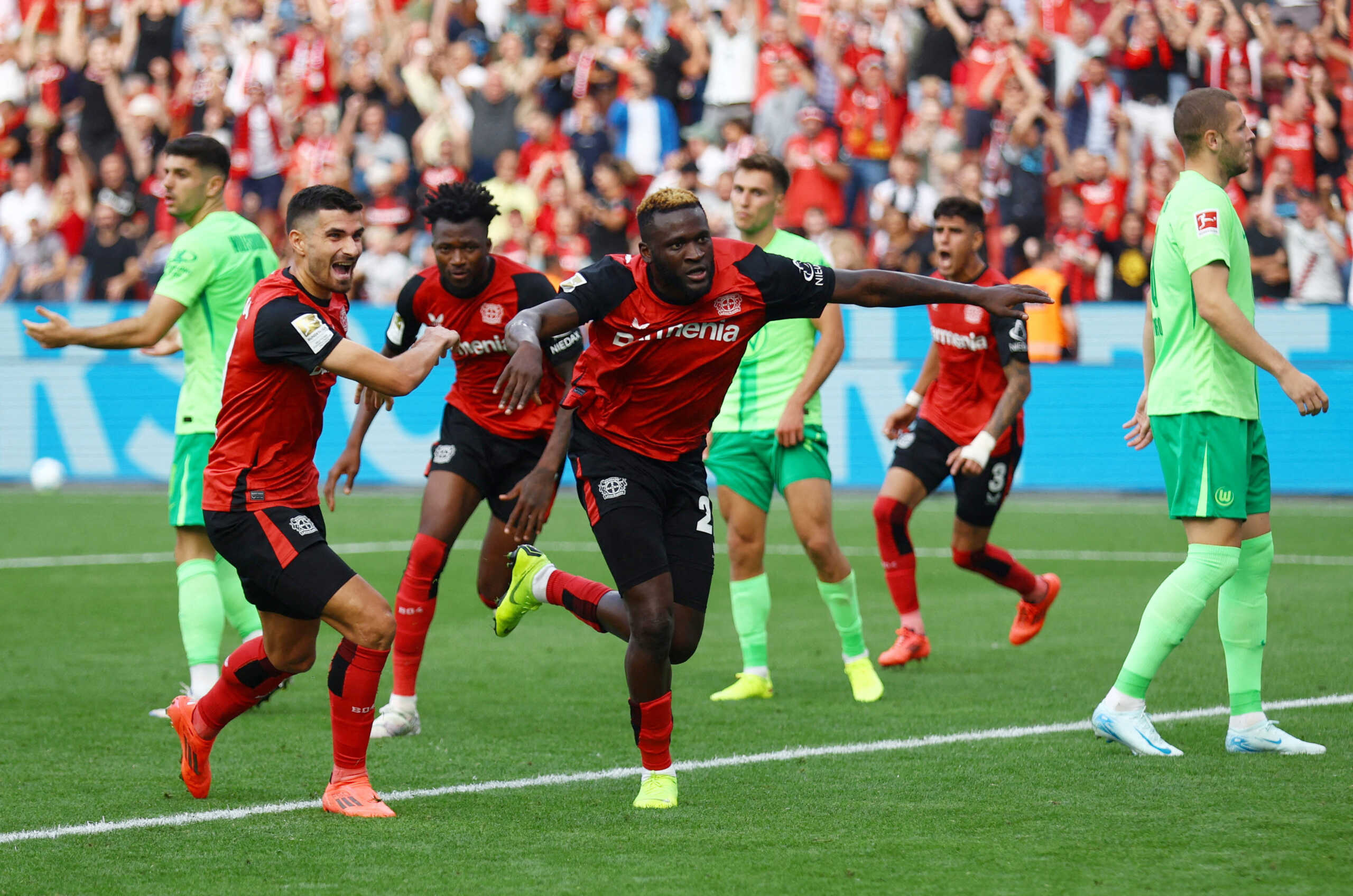 Soccer Football - Bundesliga - Bayer Leverkusen v VfL Wolfsburg - BayArena, Leverkusen, Germany - September 22, 2024 Bayer Leverkusen's Victor Boniface celebrates scoring their fourth goal with Martin Terrier REUTERS