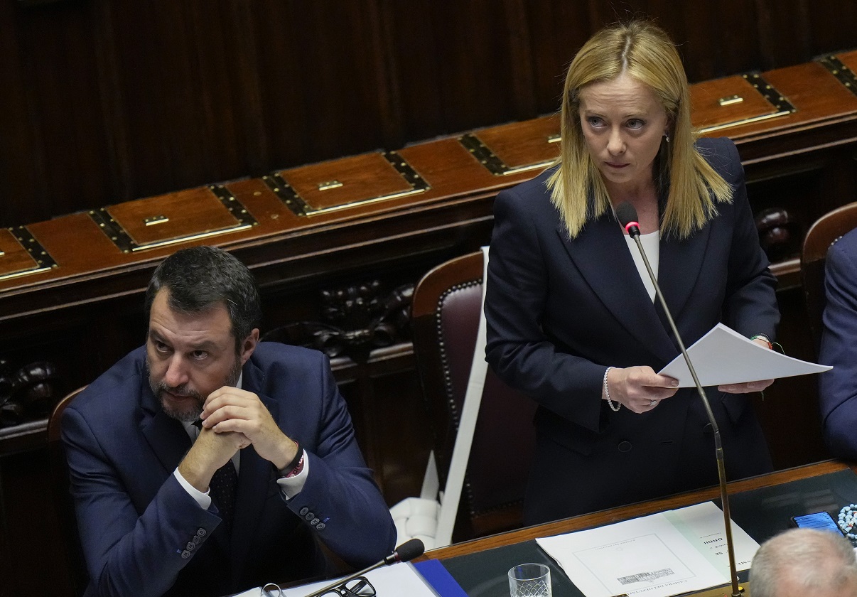 Italian Premier Giorgia Meloni, right, flanked by Infrastructures Minister Matteo Salvini, addresses the lower Chamber ahead of a confidence vote for her Cabinet, Tuesday, Oct. 25, 2022. Giorgia Meloni, whose party with neo-fascist roots finished first in recent elections, is Italy's first far-right premier since the end of World War II. She is also the first woman to serve as Italian premier. (AP Photo