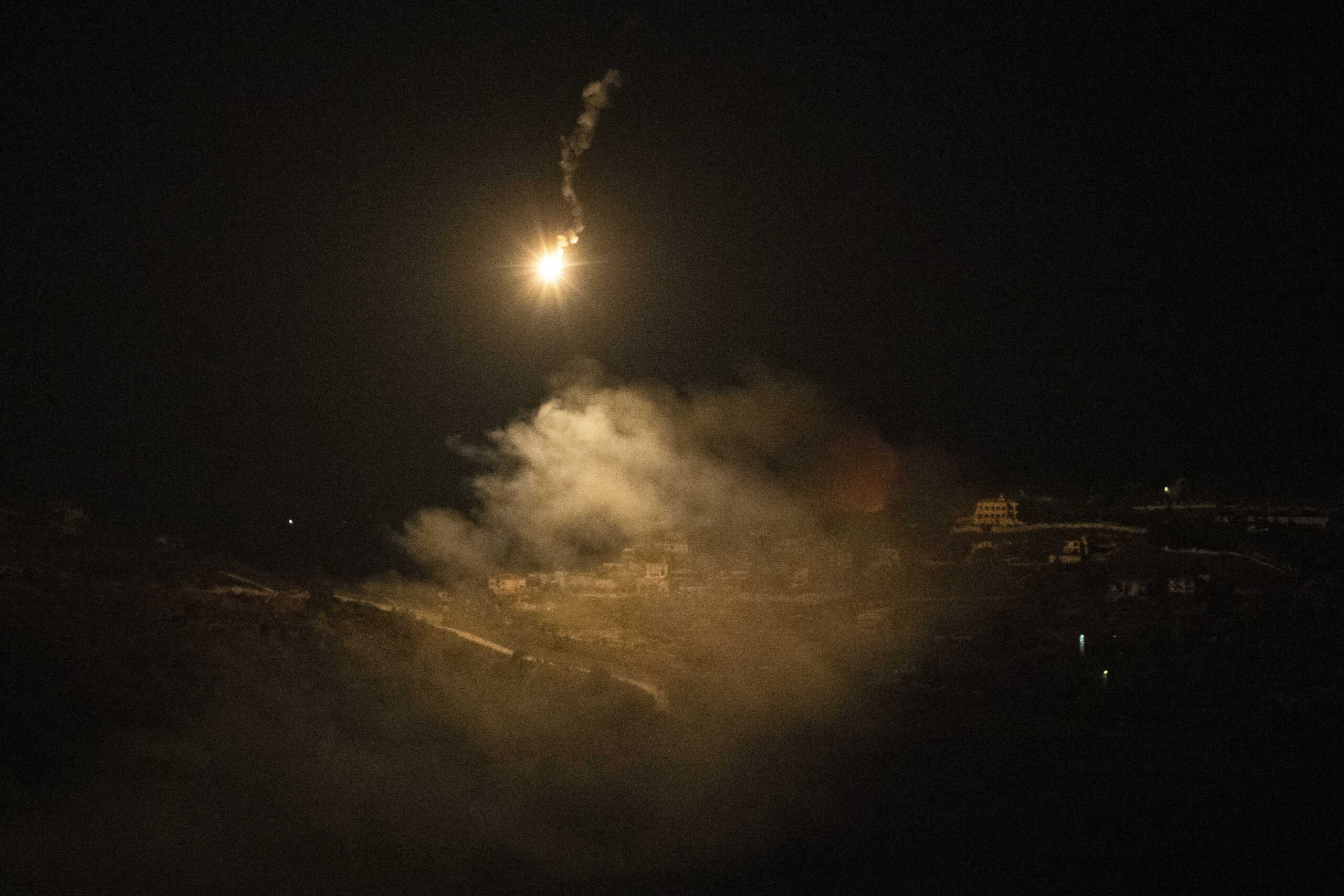 An Israeli army flare is seen over the Israeli-Lebanese border at the Galilee region as seen from the Israeli-annexed Golan Heights, Saturday, Aug. 3, 2024. (AP Photo