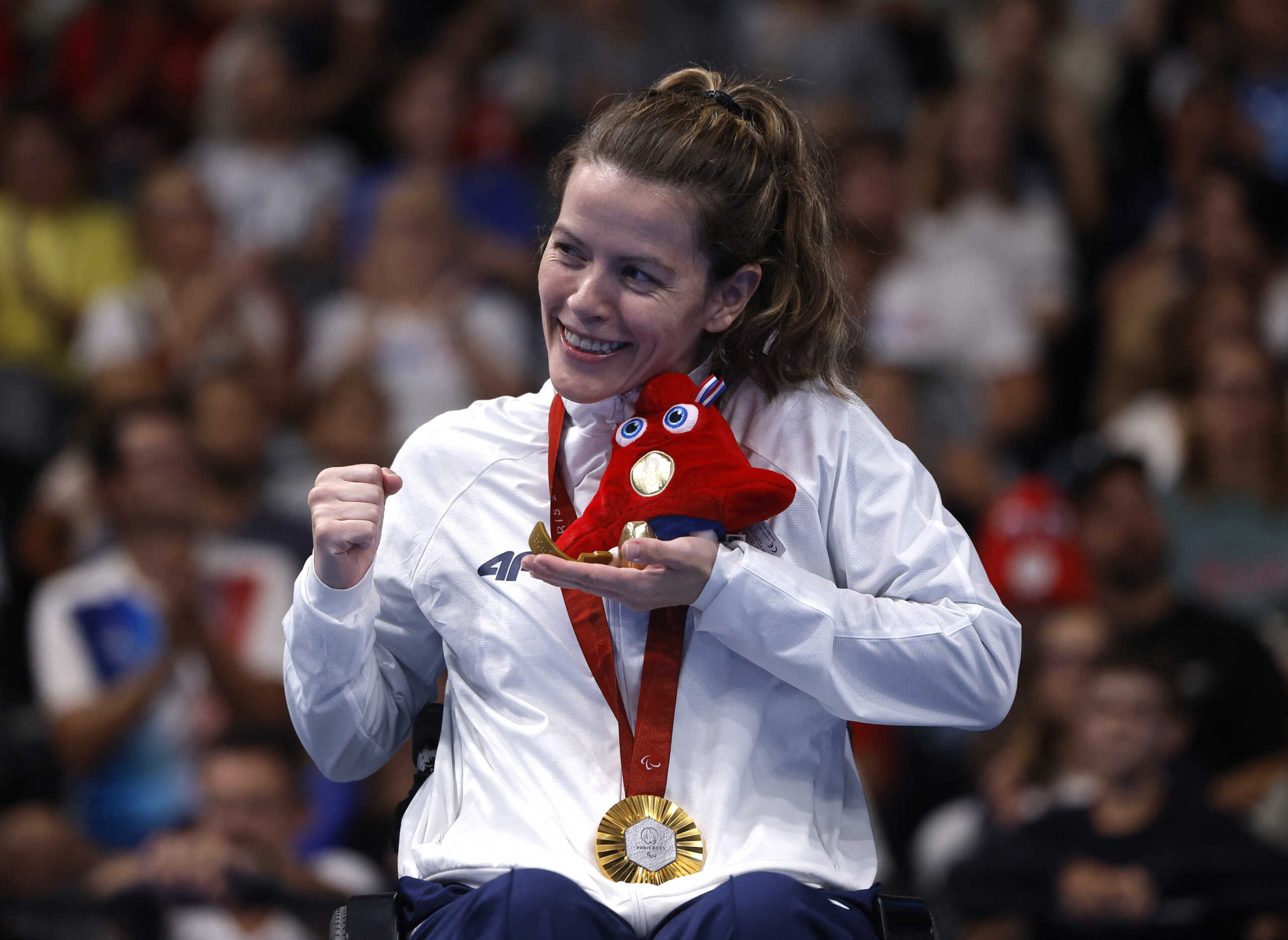 Paris 2024 Paralympics - Swimming - Women's 50m Backstroke - S4 Medal Ceremony - Paris La Defense Arena, Nanterre, France - September 7, 2024 Gold medallist Alexandra Stamatopoulou of Greece celebrates on the podium REUTERS