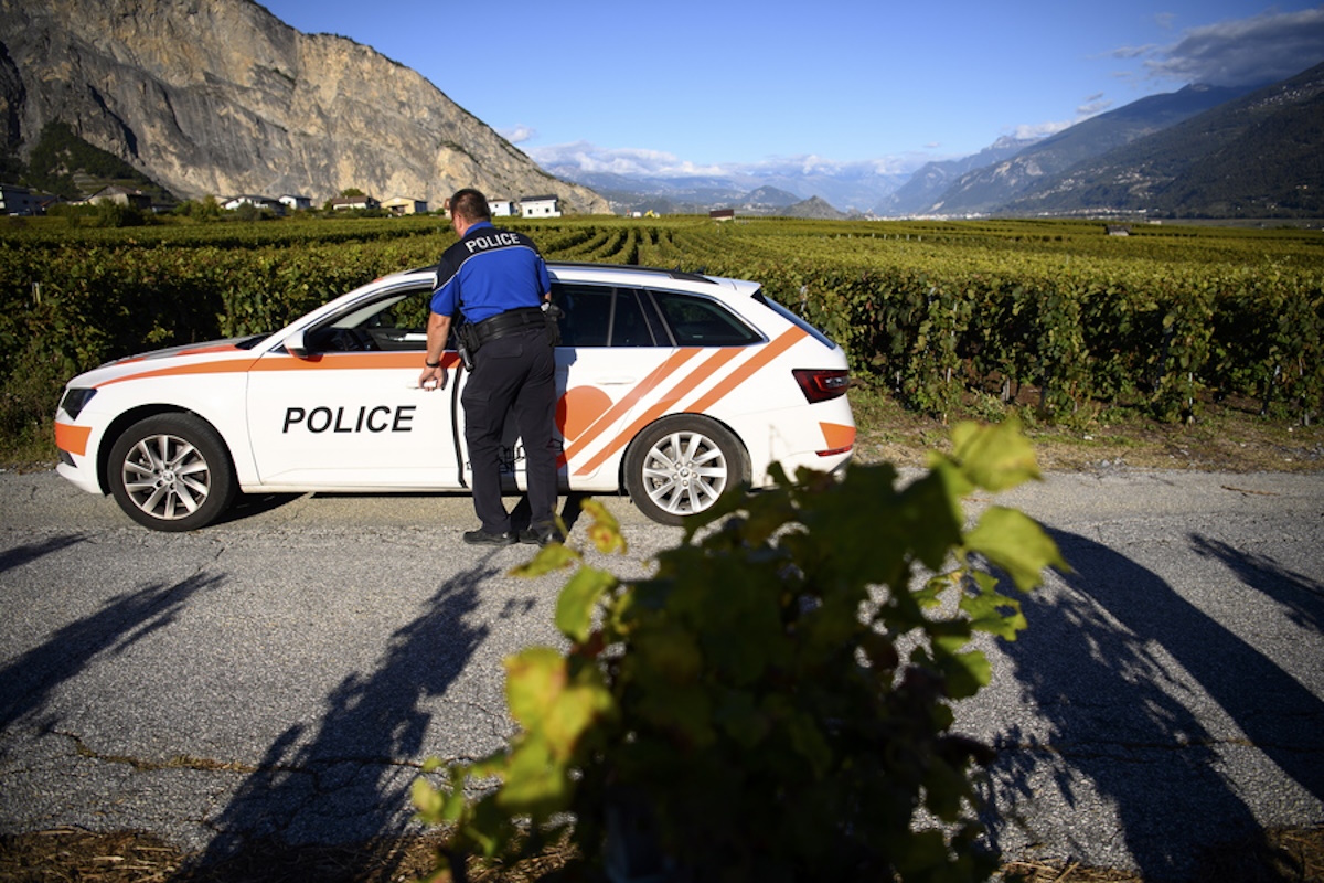 epa09512587 A police officer of the municipal police is doing a round of surveillance in the vineyard to fight against grape theft in Chamoson, Switzerland, 07 October 2021 (issued 08 October 2021). During the harvest period, grape thefts are observed every year in the Valais vineyards. This year, when the harvest is expected to be small and uneven, Chamoson has set up surveillance rounds at the request of the agricultural union.  EPA