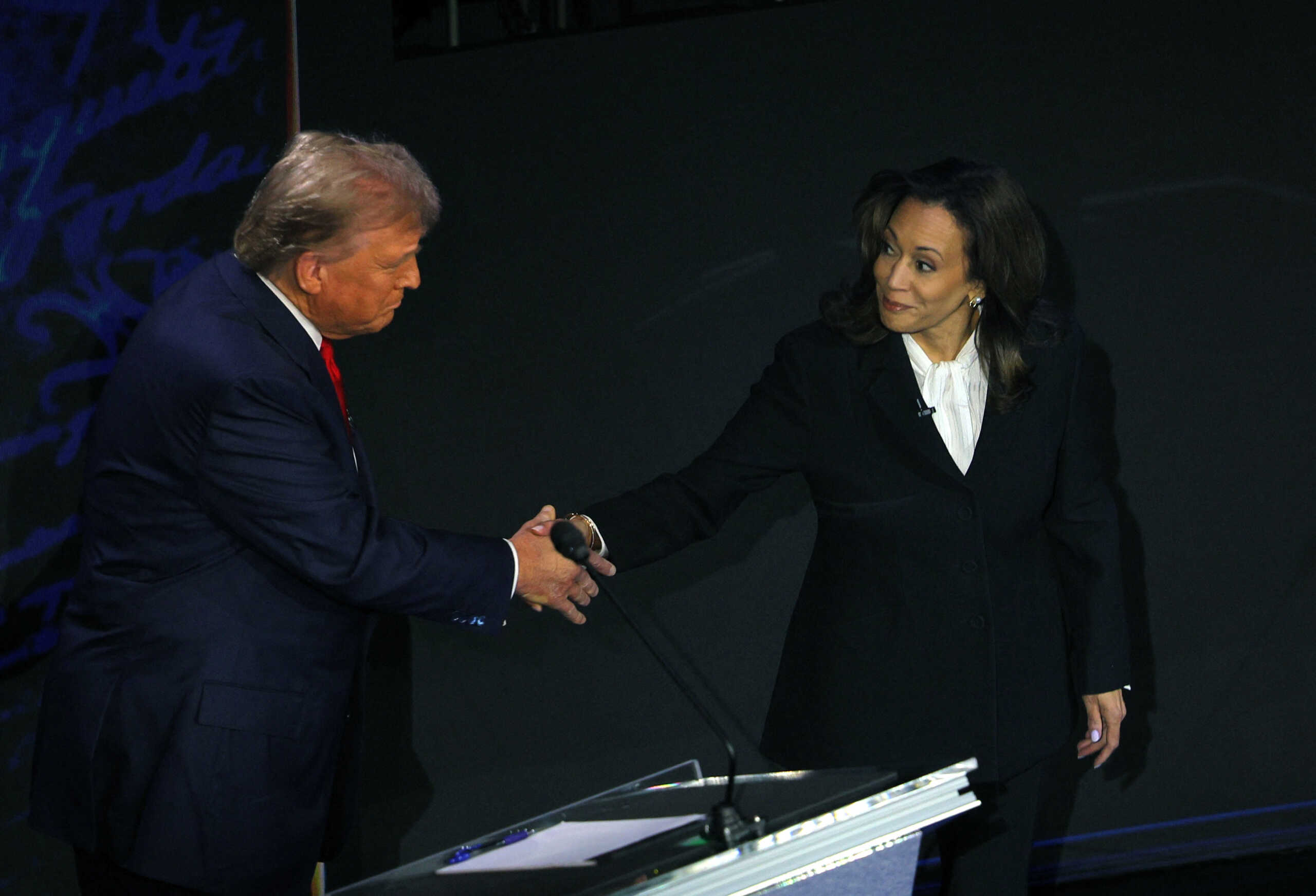 Republican presidential nominee, former U.S. President Donald Trump and Democratic presidential nominee, U.S. Vice President Kamala Harris shake hands as they arrive at their podiums to attend a presidential debate hosted by ABC in Philadelphia, Pennsylvania, U.S., September 10, 2024. REUTERS