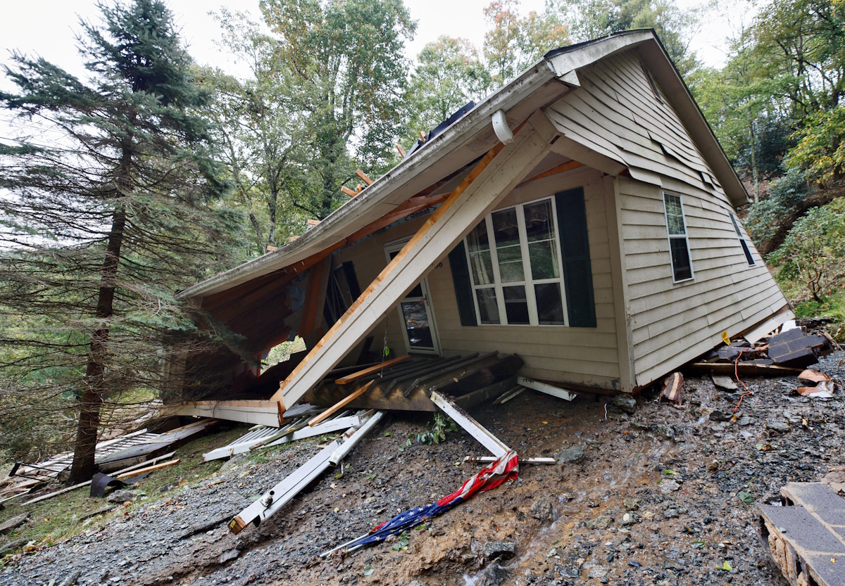 A U.S. flag lies in the mud in front of a collapsed house in the aftermath of Tropical Storm Helene, in Boone, North Carolina, U.S. September 28, 2024.  REUTERS