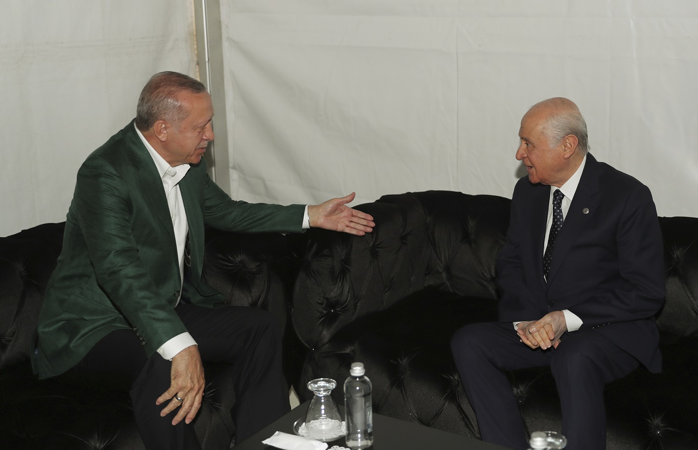 Turkey's President Recep Tayyip Erdogan, left, and Devlet Bahceli, the leader of opposition Nationalist Movement Party, MHP, speak before addressing the supporters of MHP and ruling Justice and Development Party, AKP, at a joint rally in Aegean city of Izmir, Turkey, Sunday, March 17, 2019. Erdogan's AKP and MHP made an alliance for the countrywide local elections scheduled for March 31, 2019 with 57 million registered voters.(Presidential Press Service via AP, Pool)