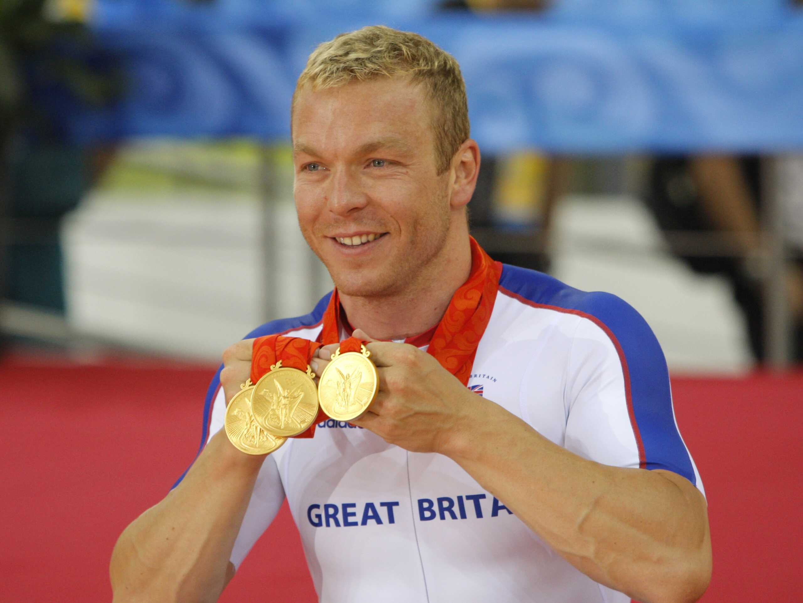 Britain's Chris Hoy shows his three gold medals of the Track Cycling, at the Beijing 2008 Olympics in Beijing,Tuesday, Aug. 19, 2008. (AP Photo