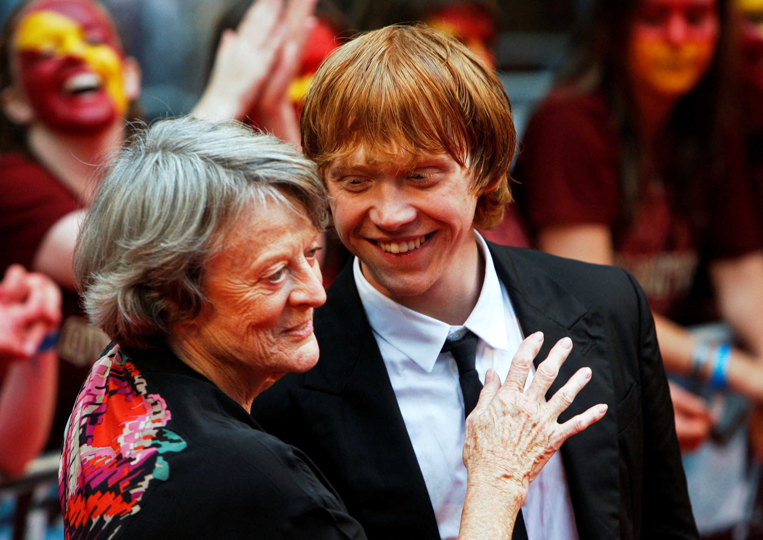 FILE PHOTO: Actors Maggie Smith and Rupert Grint share a light moment on the red carpet as they arrive for the world premiere of "Harry Potter and the Half Blood Prince" at Leicester Square in London, Britain July 7, 2009. REUTERS